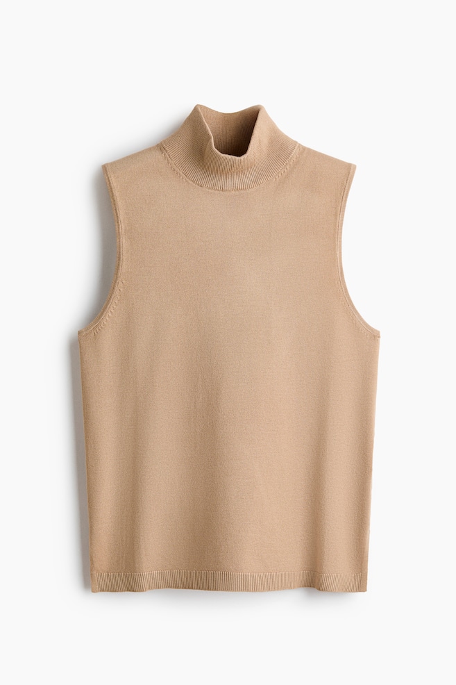 A camel knit sleeveless turtleneck top is featuring a ribbed turtleneck collar and a ribbed hem. - 1
