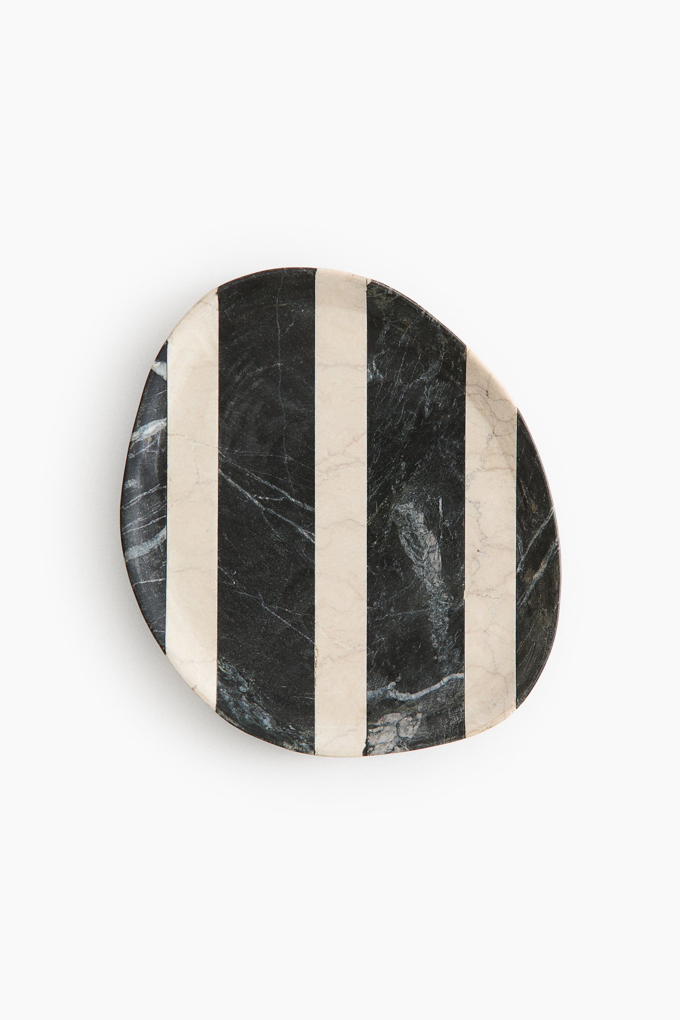 View larger image: A marble plate displays an irregular, organic shape with alternating vertical stripes of black marble and cream marble.