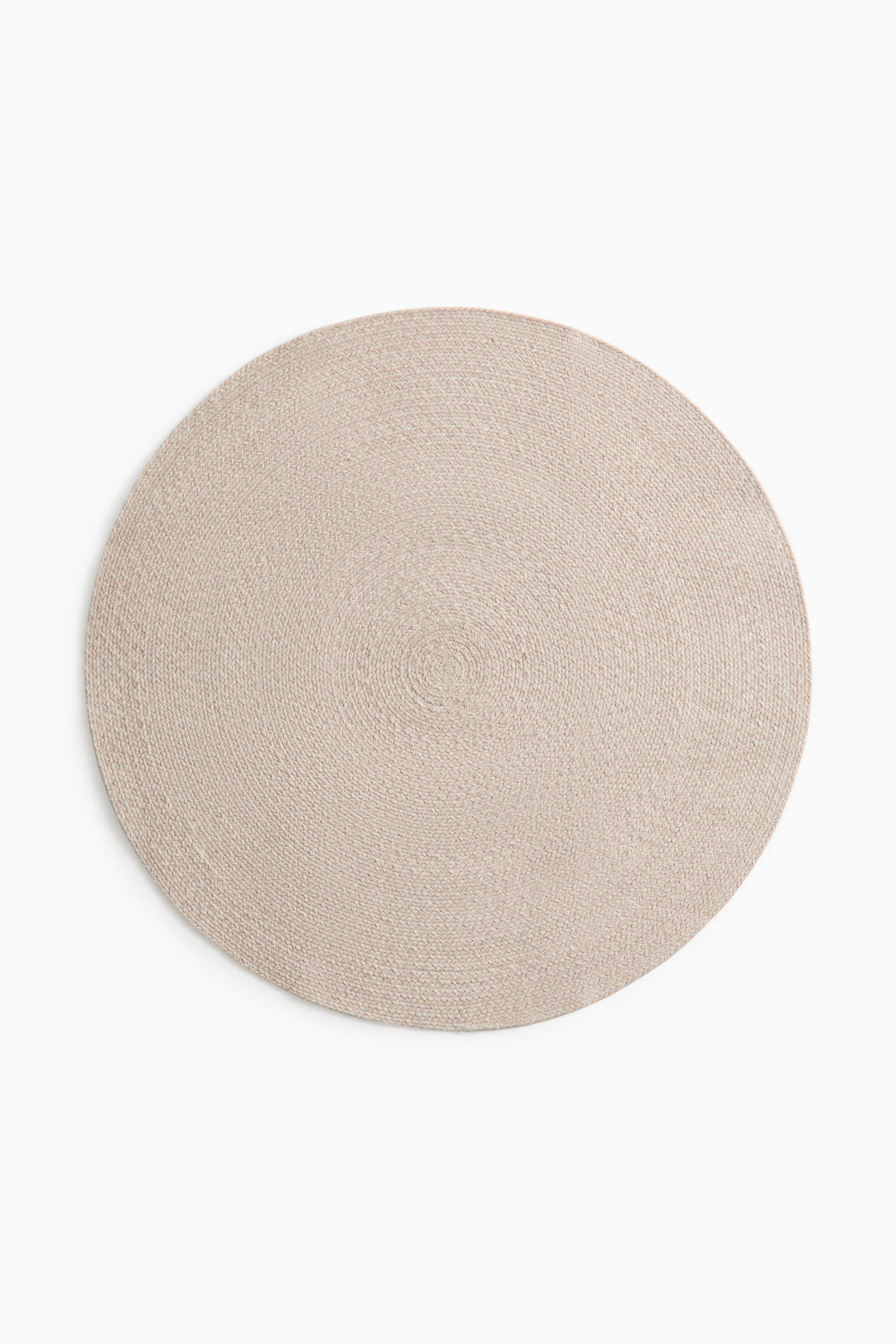 View larger image: A round placemat showcases a light beige woven texture, creating concentric rings from its center.
