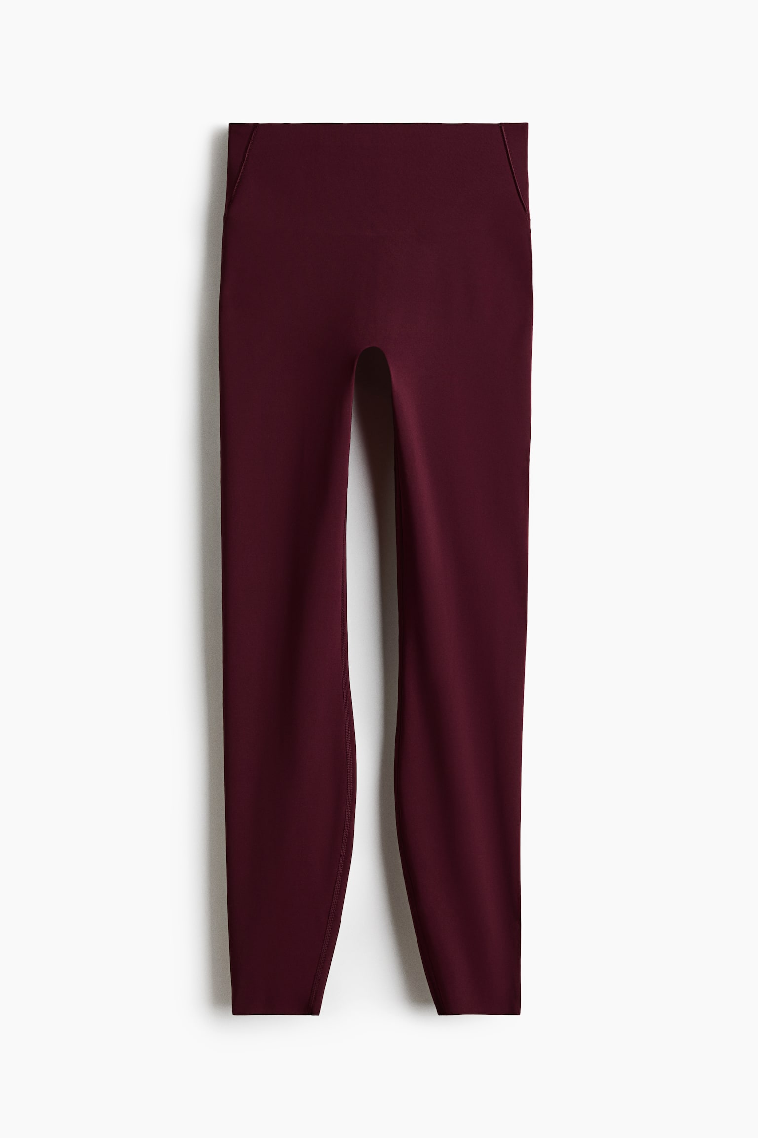 Ang mga dark red leggings ay nagtatampok ng disenyo na mataas ang baywang at may malapad na waistband. Ang mga ito ay gawa sa makinis na tela at may buong-haba na hiwa, na kumikipot hanggang sa mga bukung-bukong. - 1