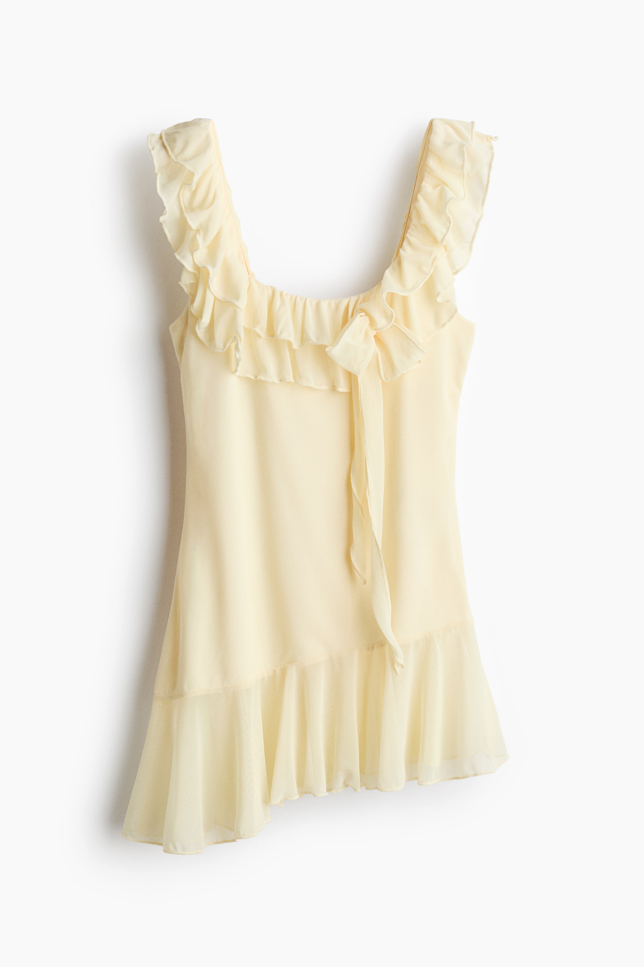 View larger image: The light yellow top features ruffled shoulder straps and a square neckline accentuated with a gathered ruffle trim. A dainty bow tie embellishes the center front neckline, while an asymmetrical ruffled hem completes the design.