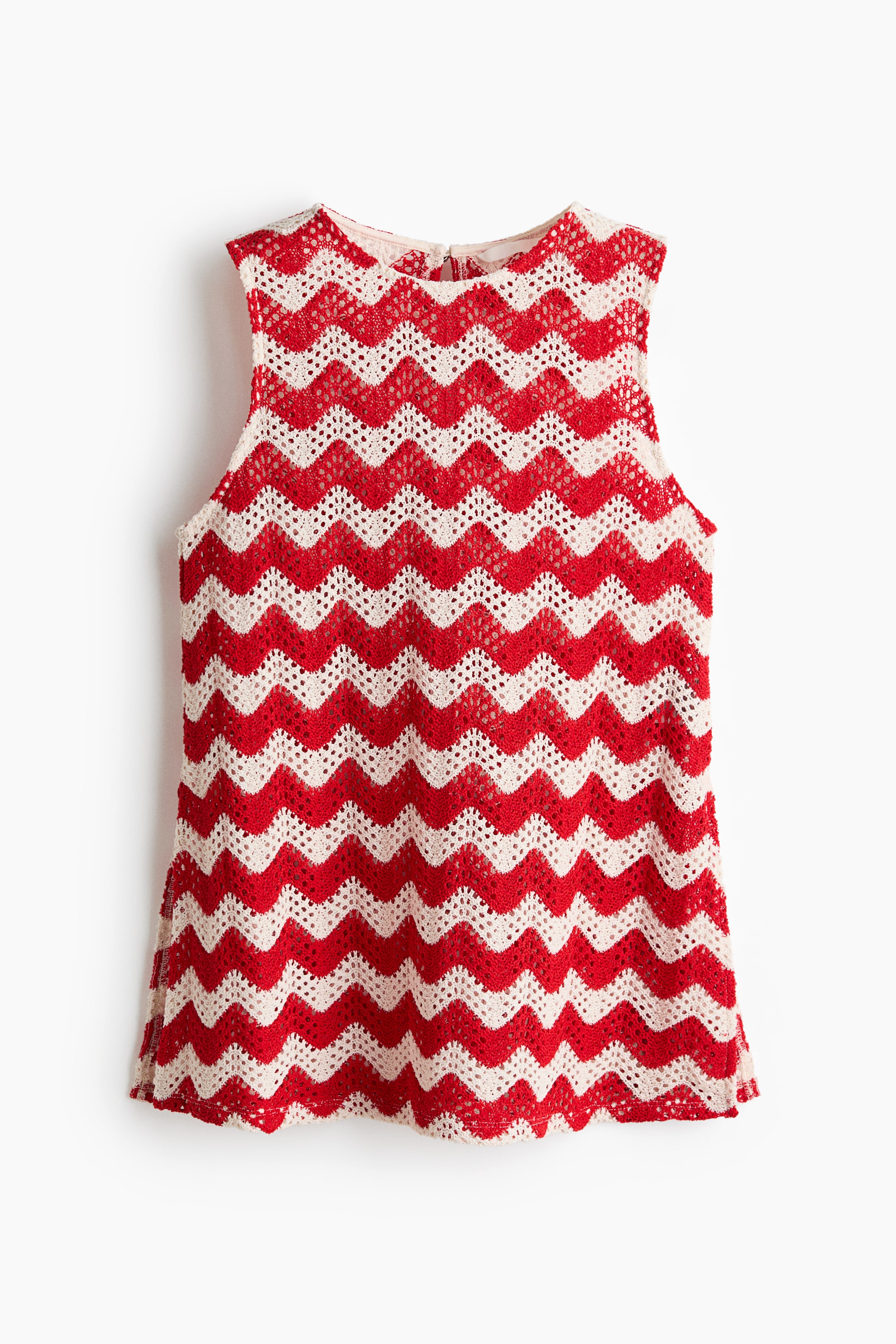 View larger image: The sleeveless top, viewed from the front, showcases a red and cream zig-zag crochet pattern with an open-knit texture, and its bottom hem finishes with a wavy edge. It features a round neckline, a sleeveless design, and a small visible zipper closure at the back of the neck.