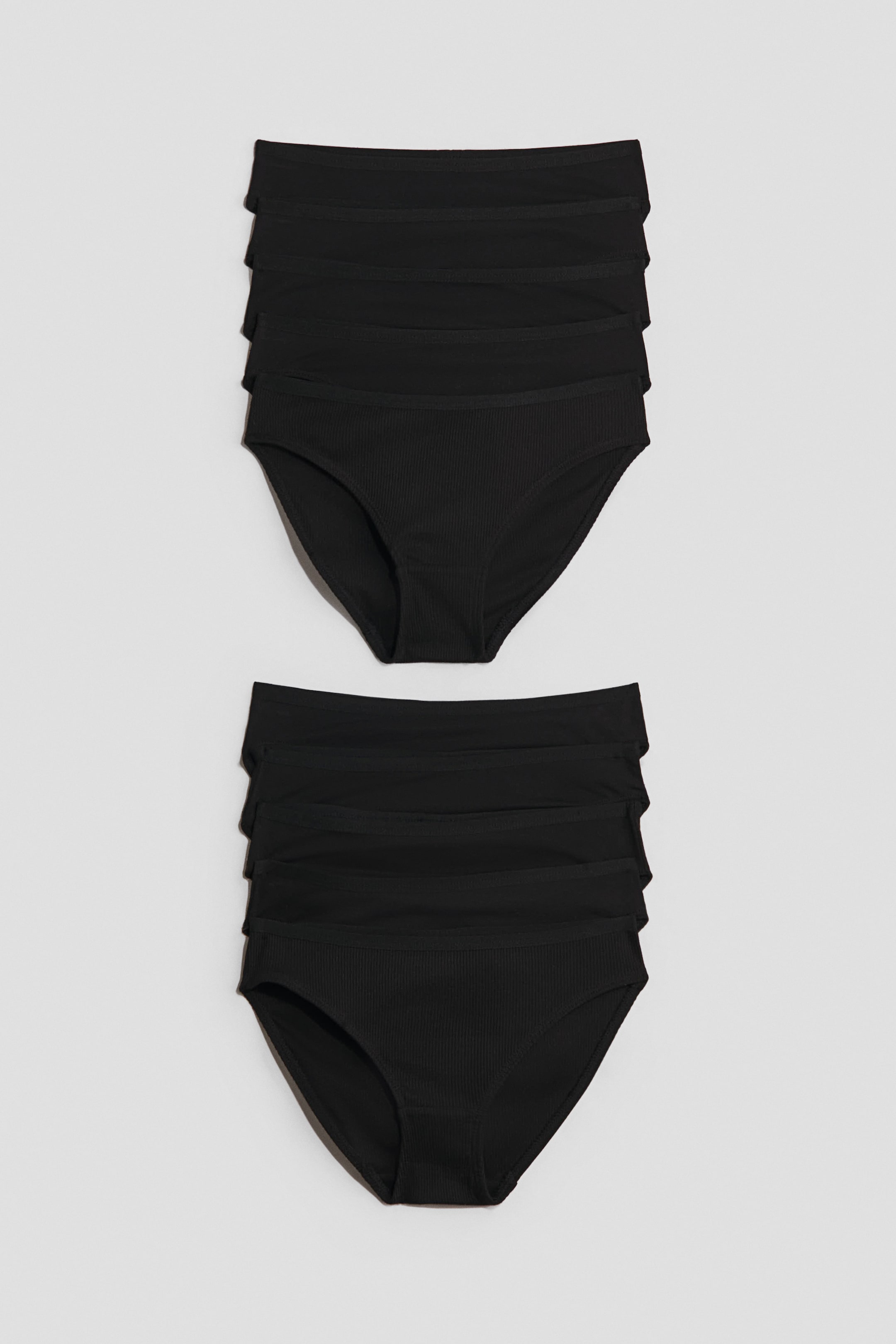 View larger image: Two stacks of black ribbed briefs are displayed, each stack showcasing multiple items. The briefs feature a classic cut.