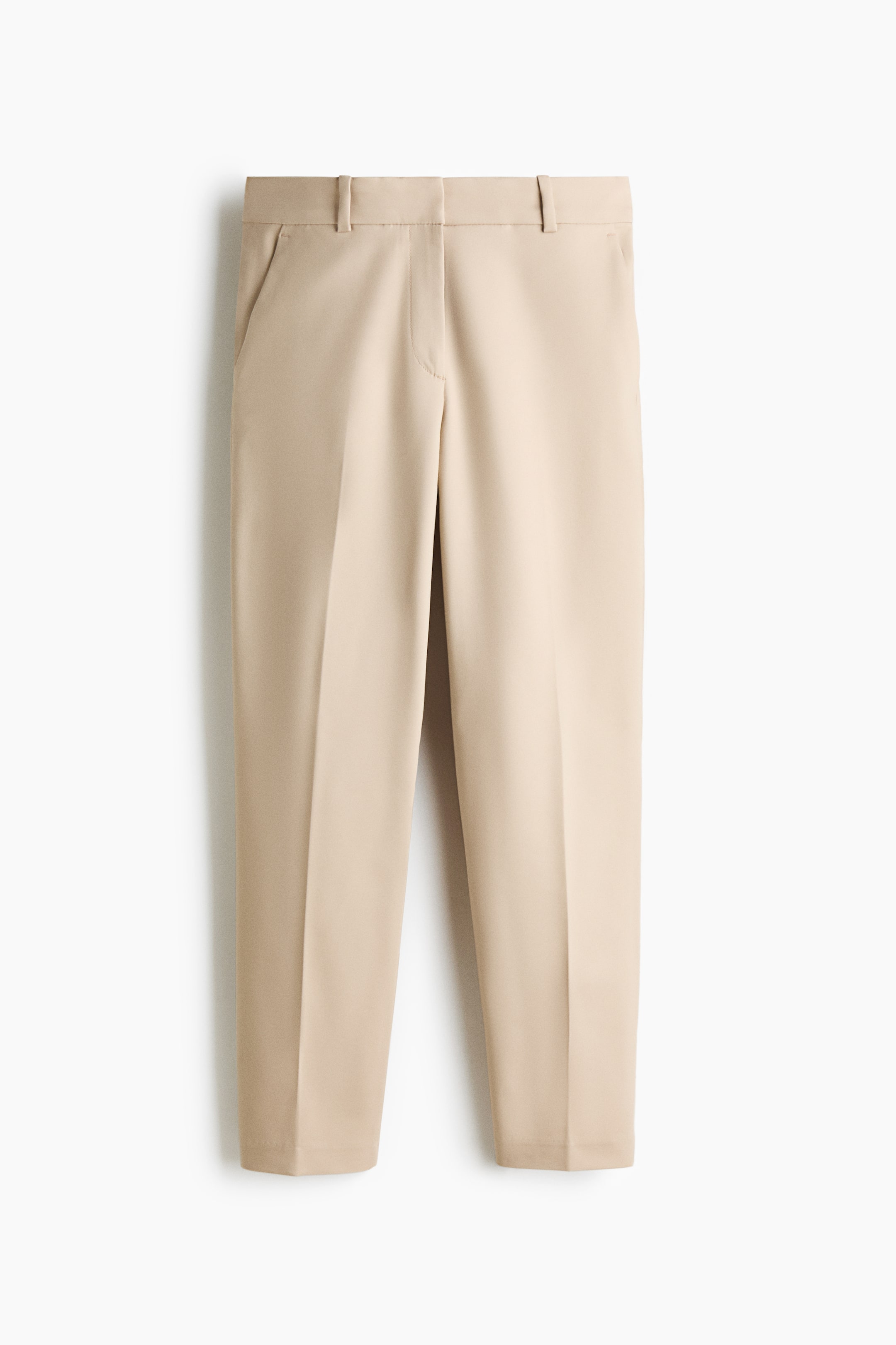 View larger image: Light beige cigarette trousers are presenting their front view, featuring a regular waist with belt loops, a zip fly with a concealed hook-and-eye fastening, and slanted side pockets. The trousers are designed with tapered legs, a visible front crease, and an ankle-length hem.