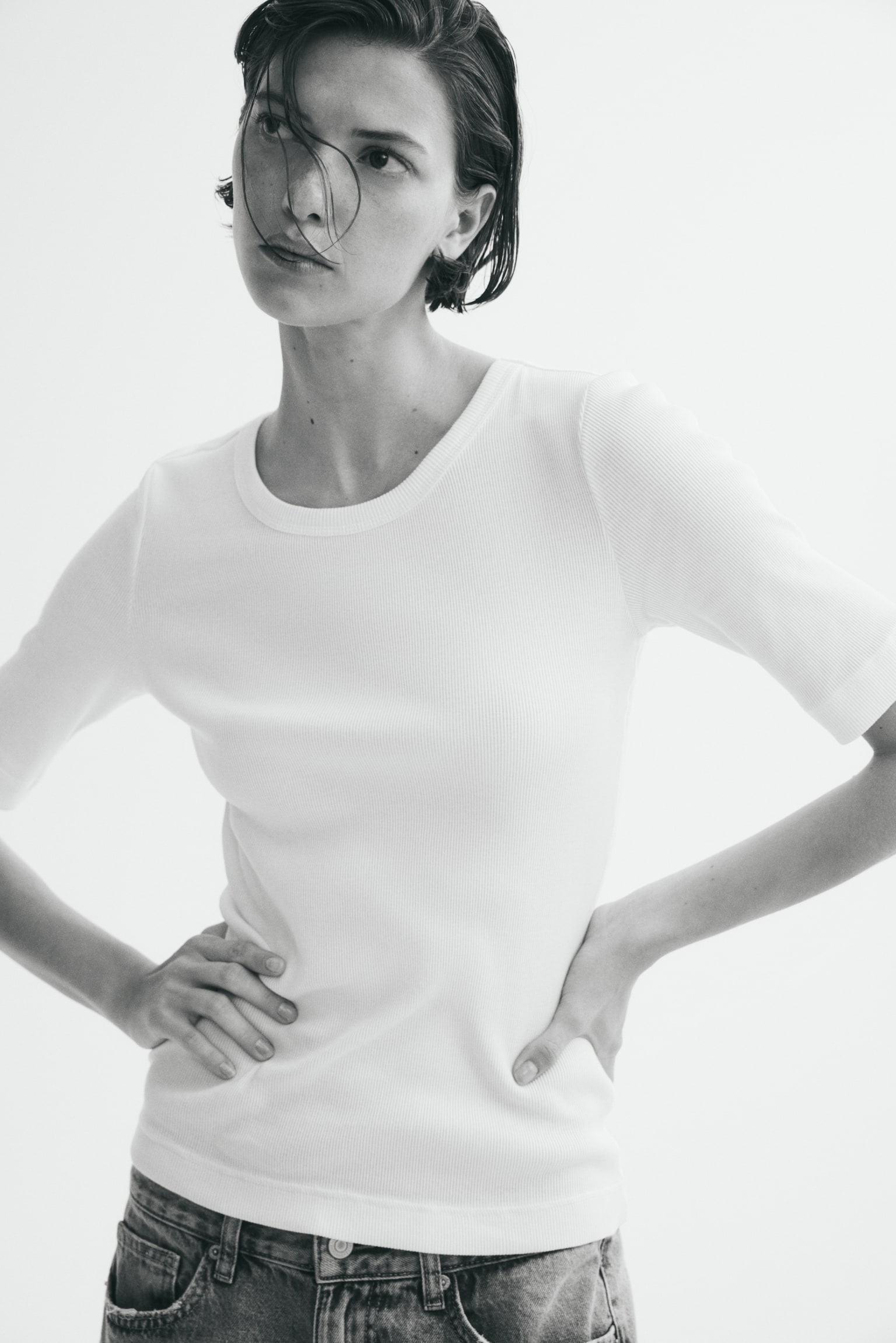 Front view of a cream ribbed knit T-shirt, featuring short sleeves and a round neckline. - 1