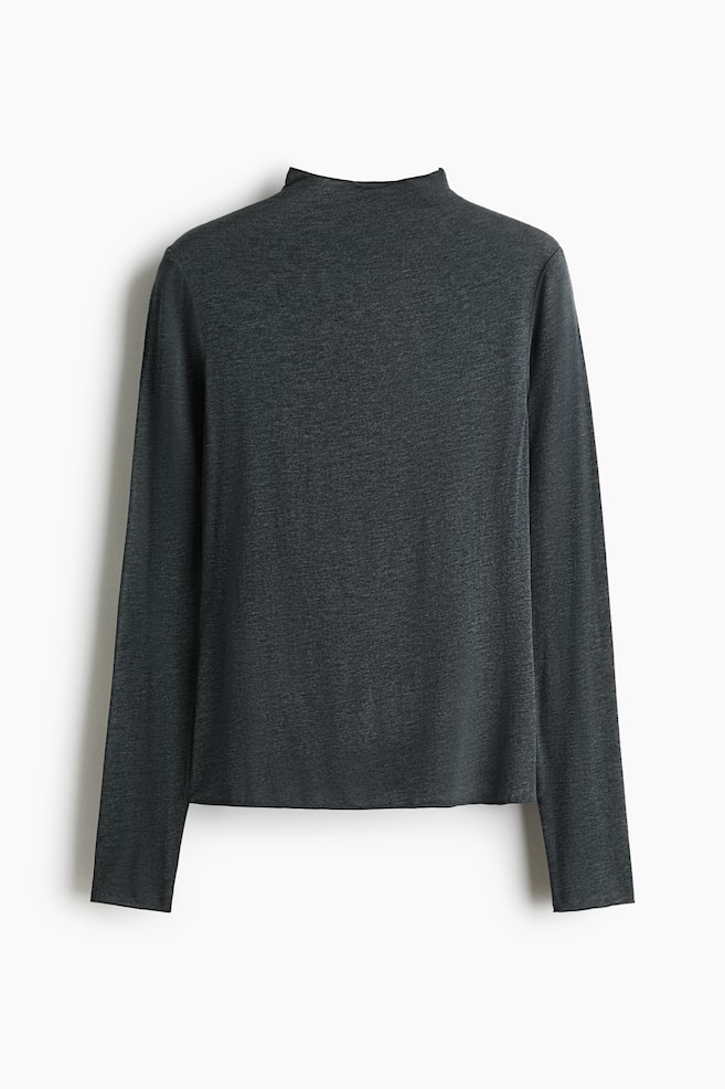 A dark gray heathered long-sleeve top featuring a mock neck is shown from the back, displaying its relaxed fit and straight hem. The garment is presenting a soft, fine-knit texture with long, straight sleeves and clean seam detailing at the shoulders. - 1