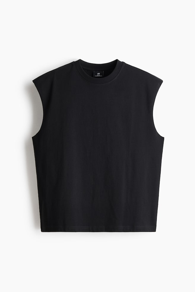 A black muscle tee is displaying a front view. It is featuring a ribbed crew neck, wide armholes, and a straight hem. - 1