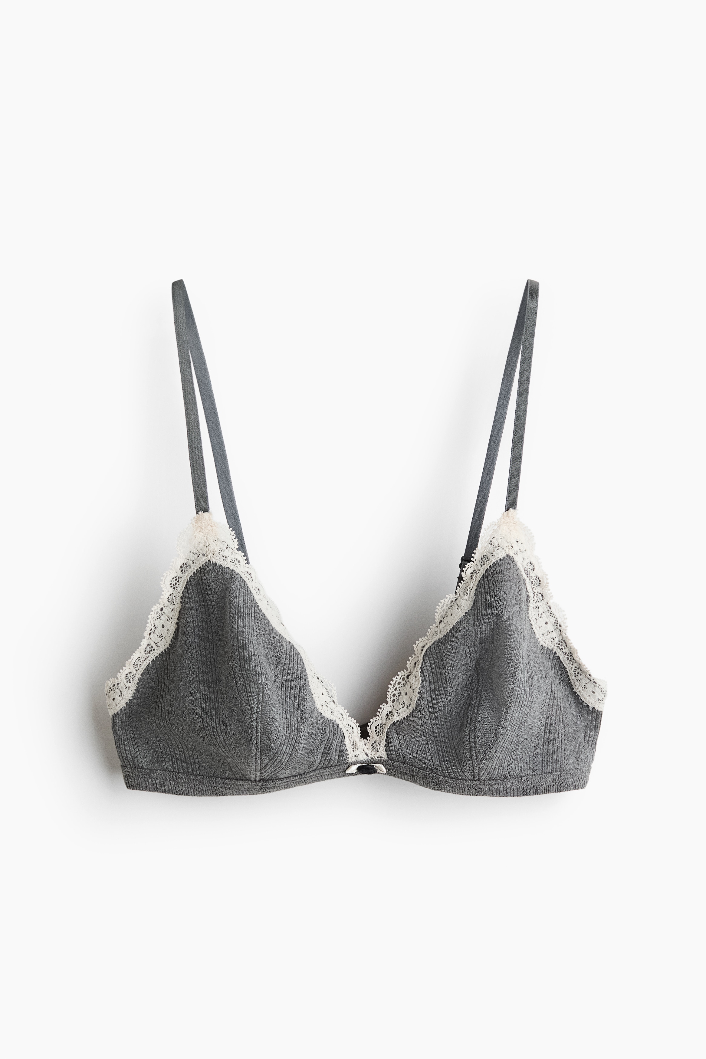 A gray melange bralette and matching brief set is shown from the front. The triangle-cup bralette features white lace trim along the inner edges and a small black bow at the center gore. The matching low-rise briefs feature a similar white lace trim along the waistband and leg openings, with a small black bow at the center.