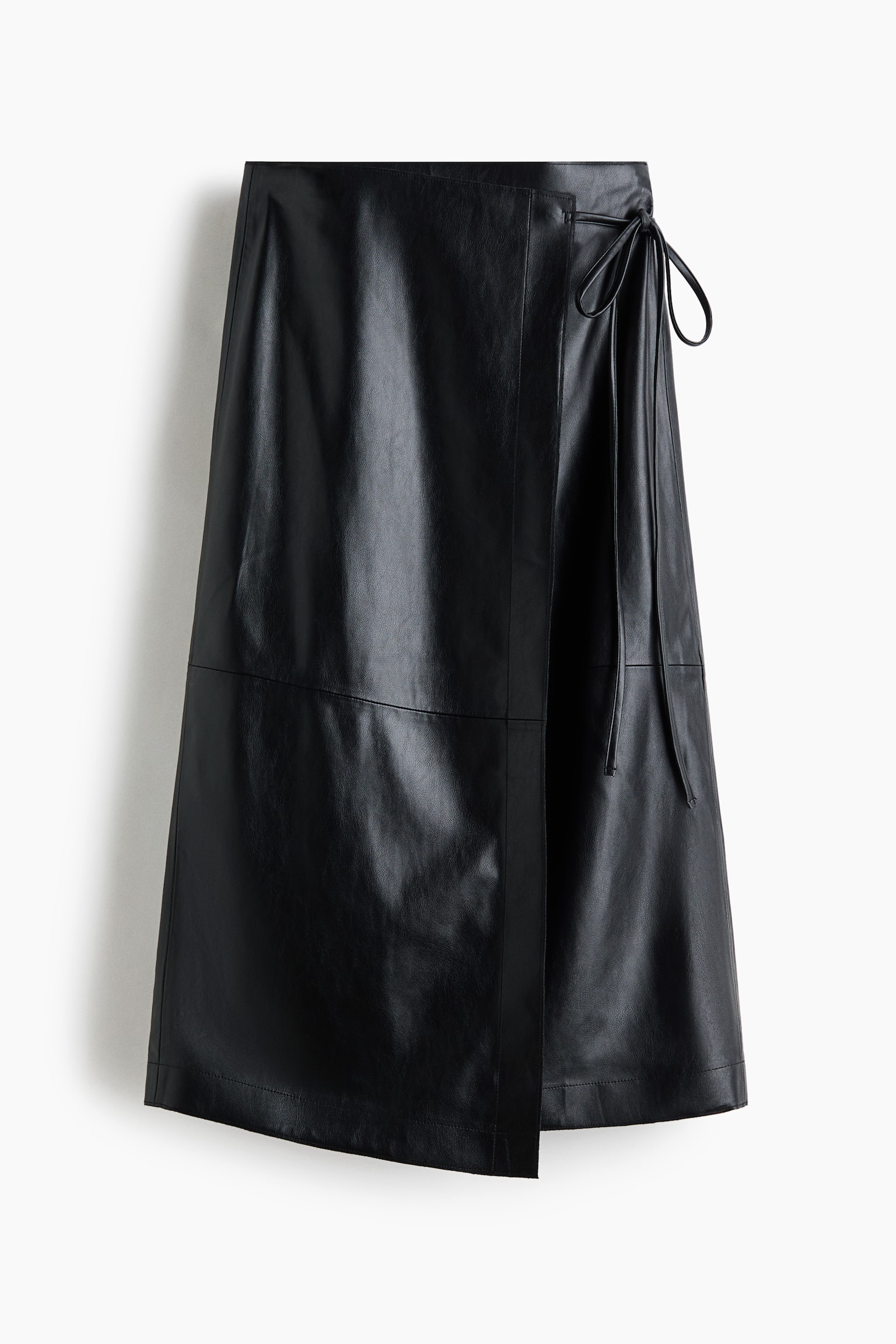 A black leather wrap skirt is hanging facing the front, featuring a wraparound design with a side tie fastening. The skirt displays an A-line silhouette with a horizontal seam running across the middle.