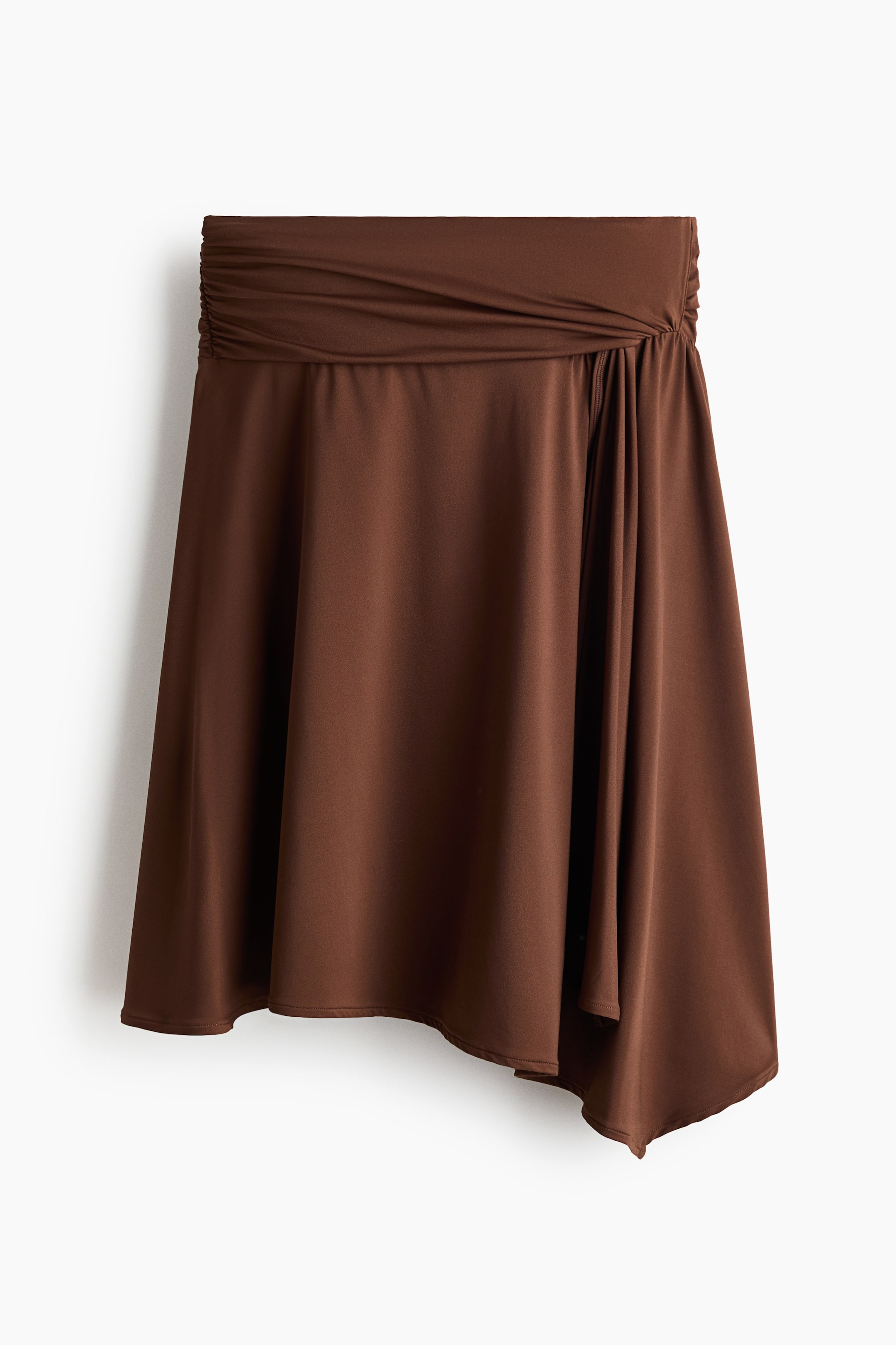 View larger image: A brown skirt featuring a wide, draped waistband that is ruched on the left side and gathered on the right. The skirt flows with an asymmetrical hemline.
