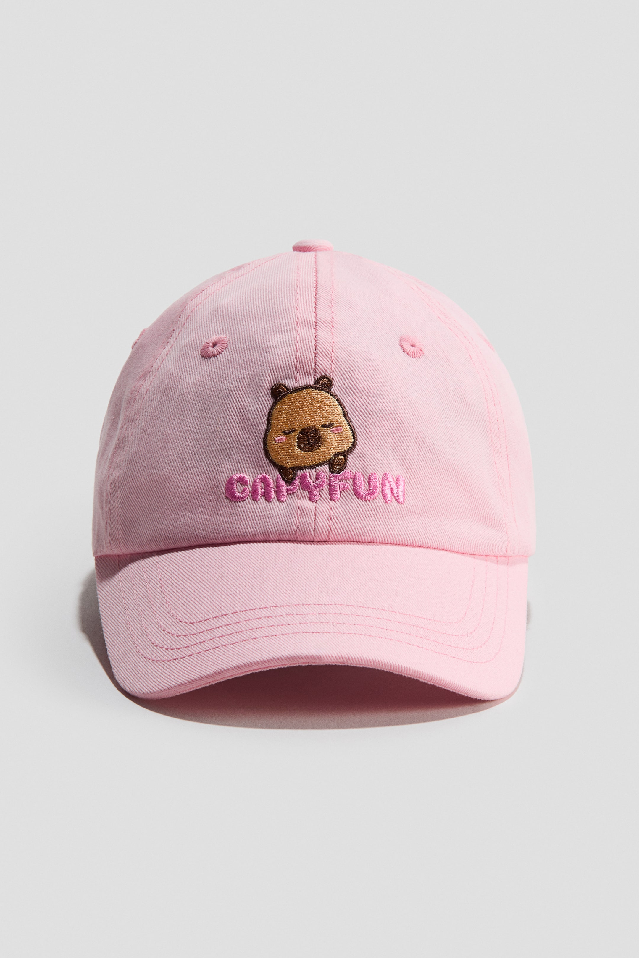 View larger image: A pink cap in soft cotton twill faces forward, showcasing an embroidered sleeping brown bear and "CAPYFUN" text on the front, complete with a curved brim.