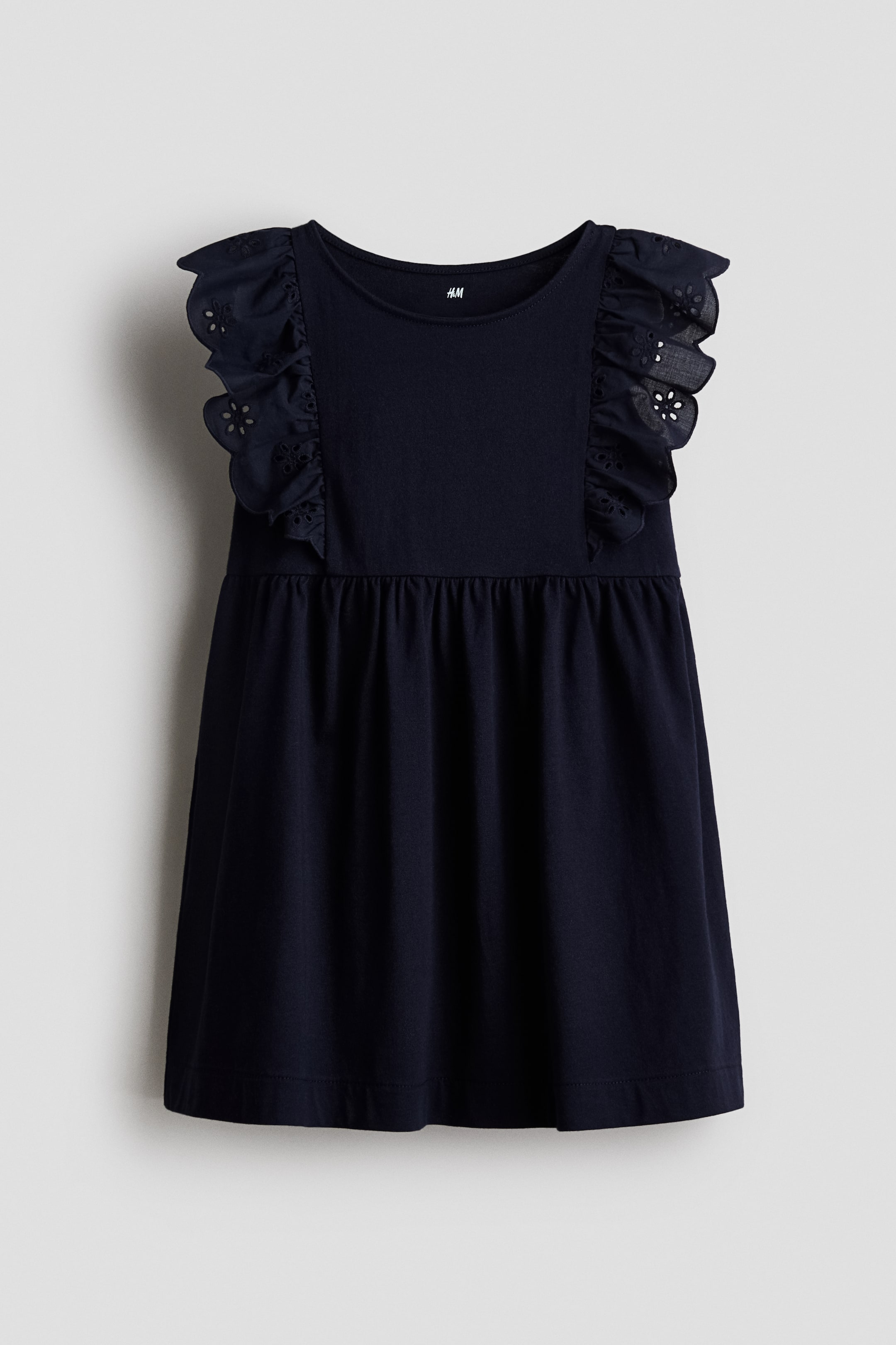 View larger image: Navy blue dress is facing FRONT, featuring a rounded neckline, ruffled sleeves with scalloped eyelet embroidery, a fitted bodice, a gathered waistline, and a flowing skirt.