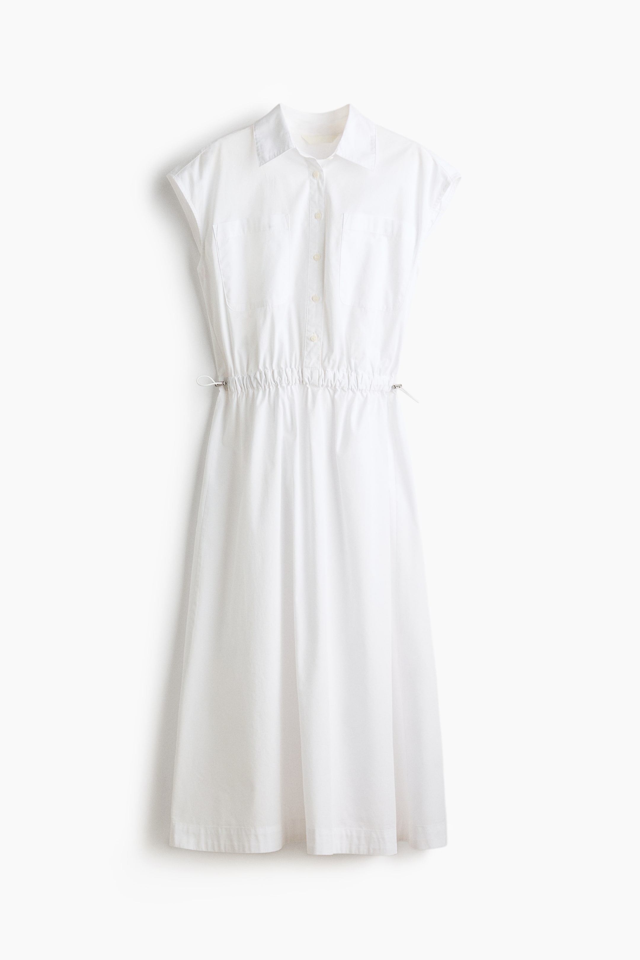 View larger image: The white dress showcases a shirt collar, cap sleeves, a button-front placket with two chest flap pockets, and an adjustable drawstring waist with silver-toned toggles, flowing into a midi skirt.