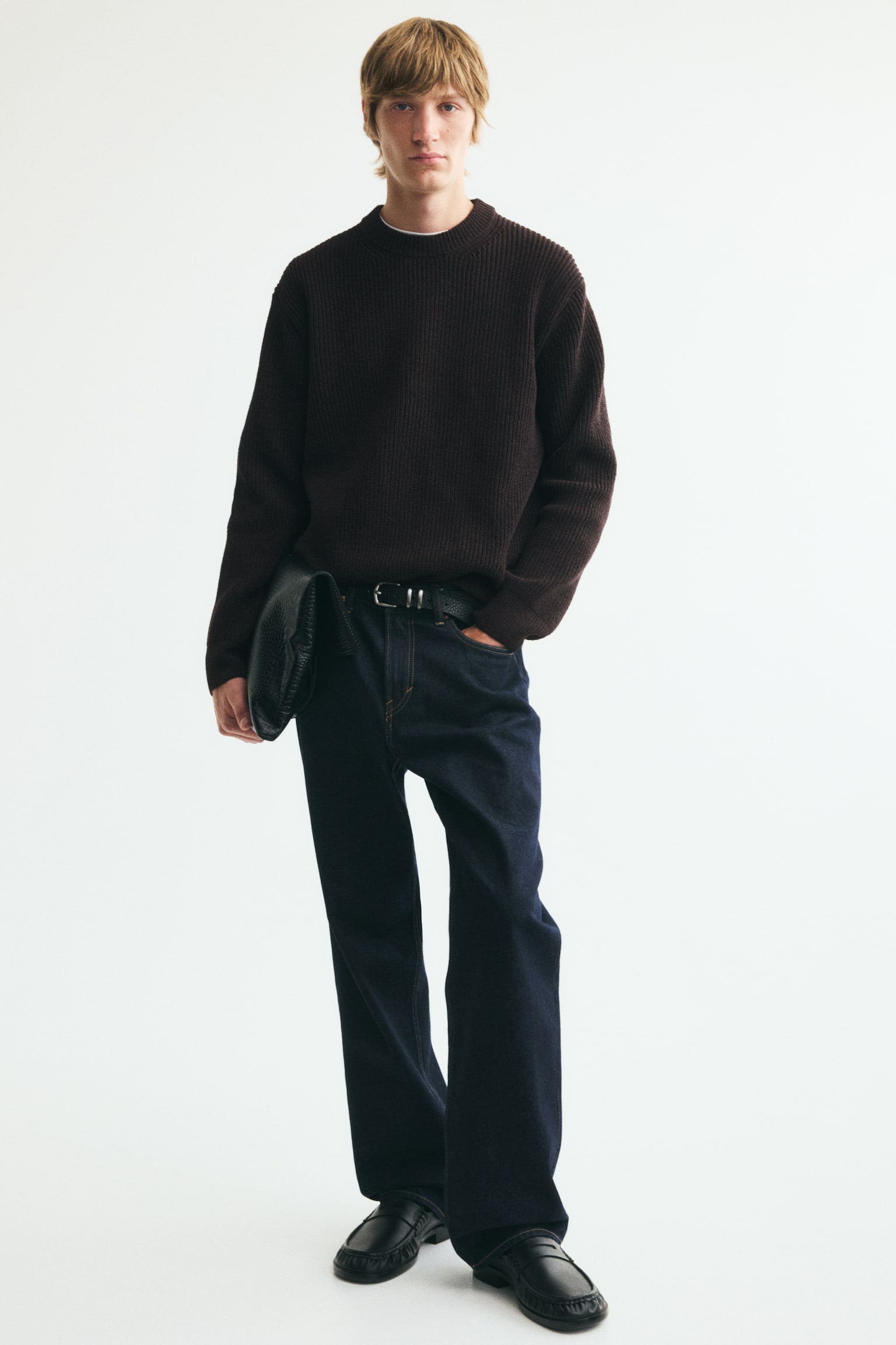 A dark brown ribbed knit jumper is being displayed, featuring a crew neck and ribbed cuffs and hem. - 1