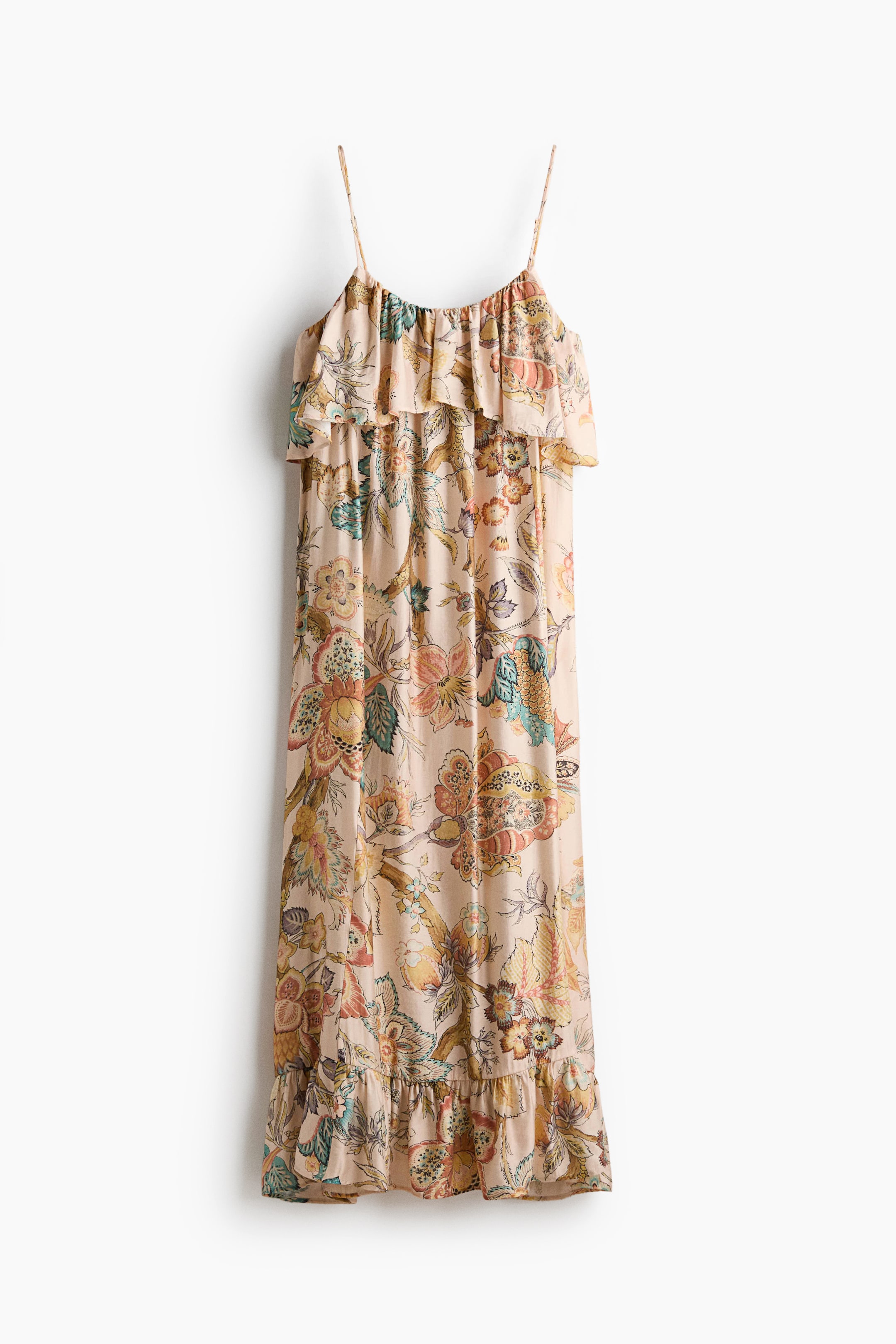 View larger image: The maxi dress showcases a light beige base adorned with a vibrant floral and paisley print in a spectrum of colours. It features delicate spaghetti straps, an elasticized neckline complemented by a ruffled overlay across the chest, and a flowing silhouette finished with a ruffled hem.