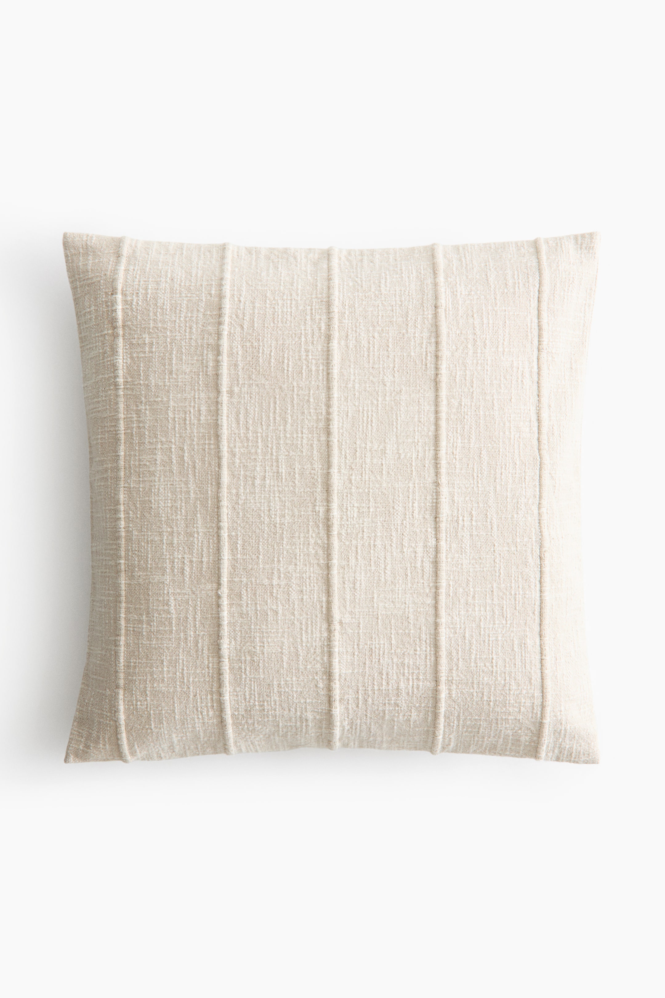 View larger image: A rectangular cream-coloured pillow showcasing a textured woven fabric. It displays five vertical stitched channels across its front surface.