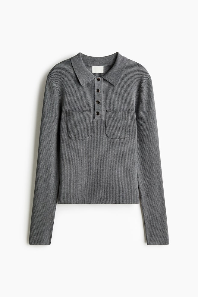 A grey ribbed-knit long-sleeved polo shirt is shown from the front, featuring a pointed collar, a partial button placket with four dark buttons, and two symmetrical chest patch pockets. - 1
