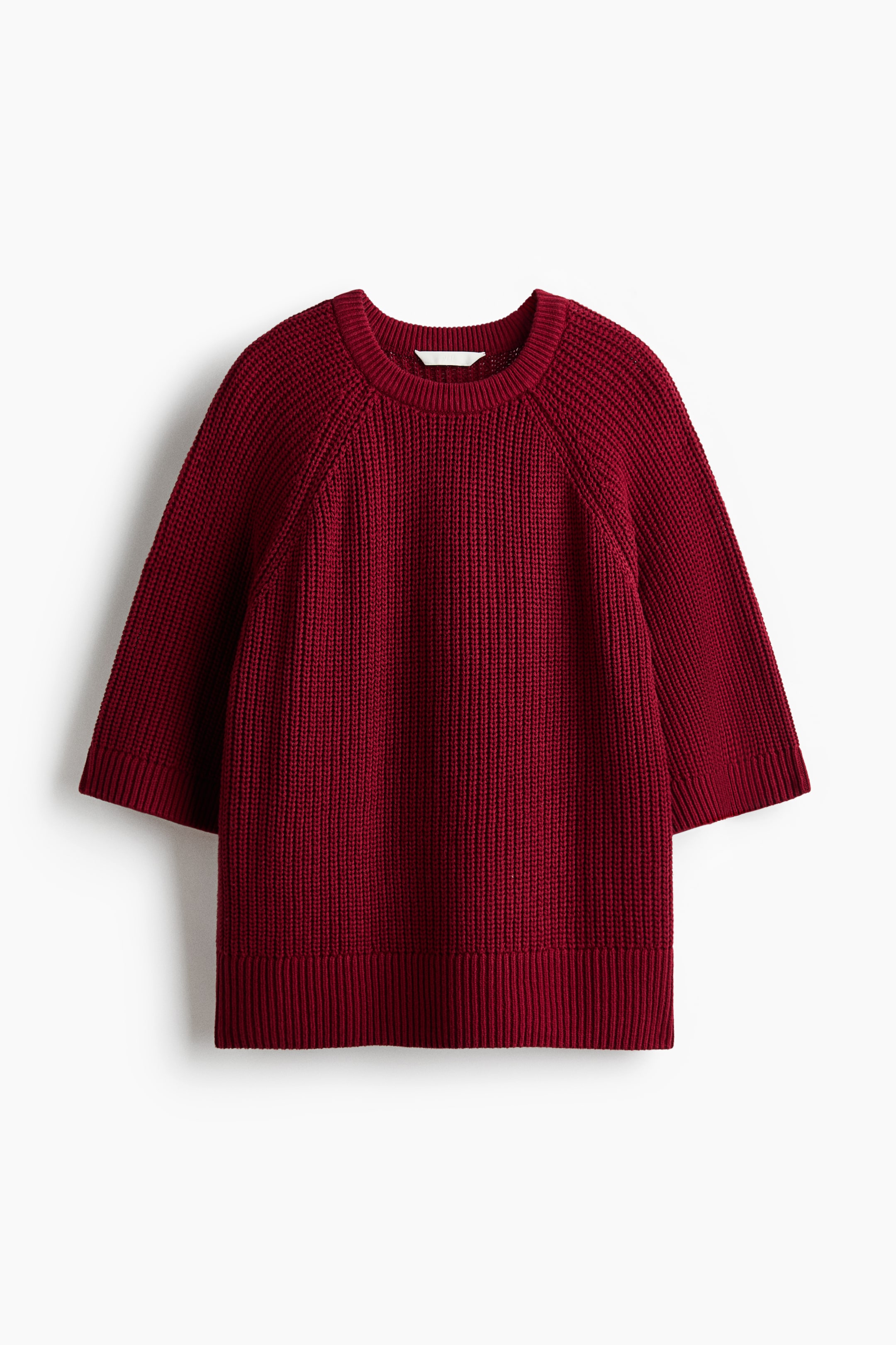 View larger image: A red sweater featuring a prominent vertical rib knit pattern on the body, three-quarter raglan sleeves, a crew neck, and tighter ribbed cuffs and hem, facing front.