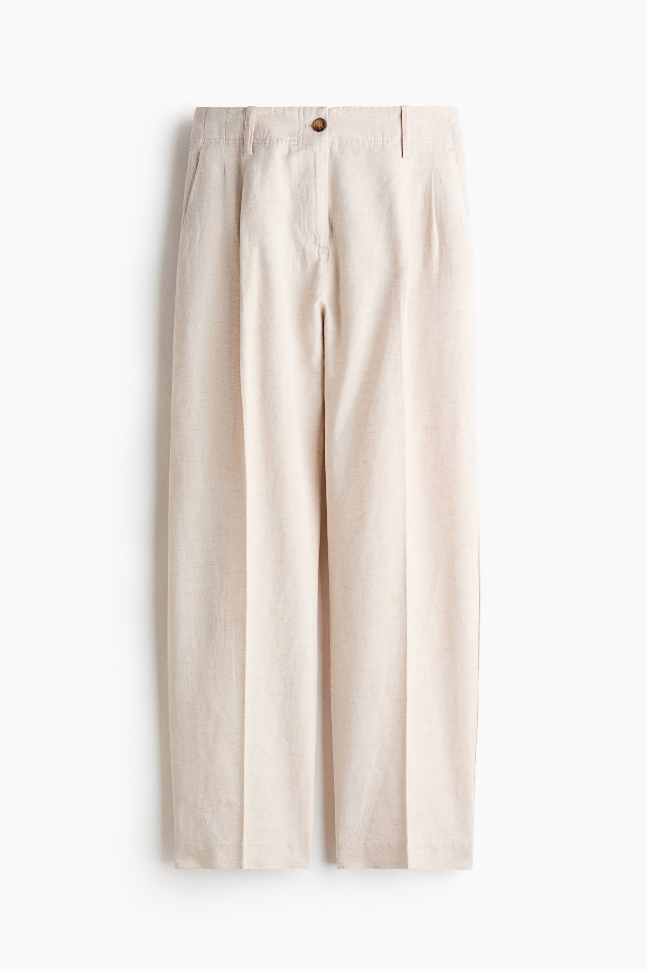 View larger image: A pair of light beige trousers featuring a textured fabric and a front perspective. They showcase a fixed waistband with belt loops, a single visible button closure, a zipper fly, and front pleats. Side pockets are evident, and the wide legs exhibit a central crease.