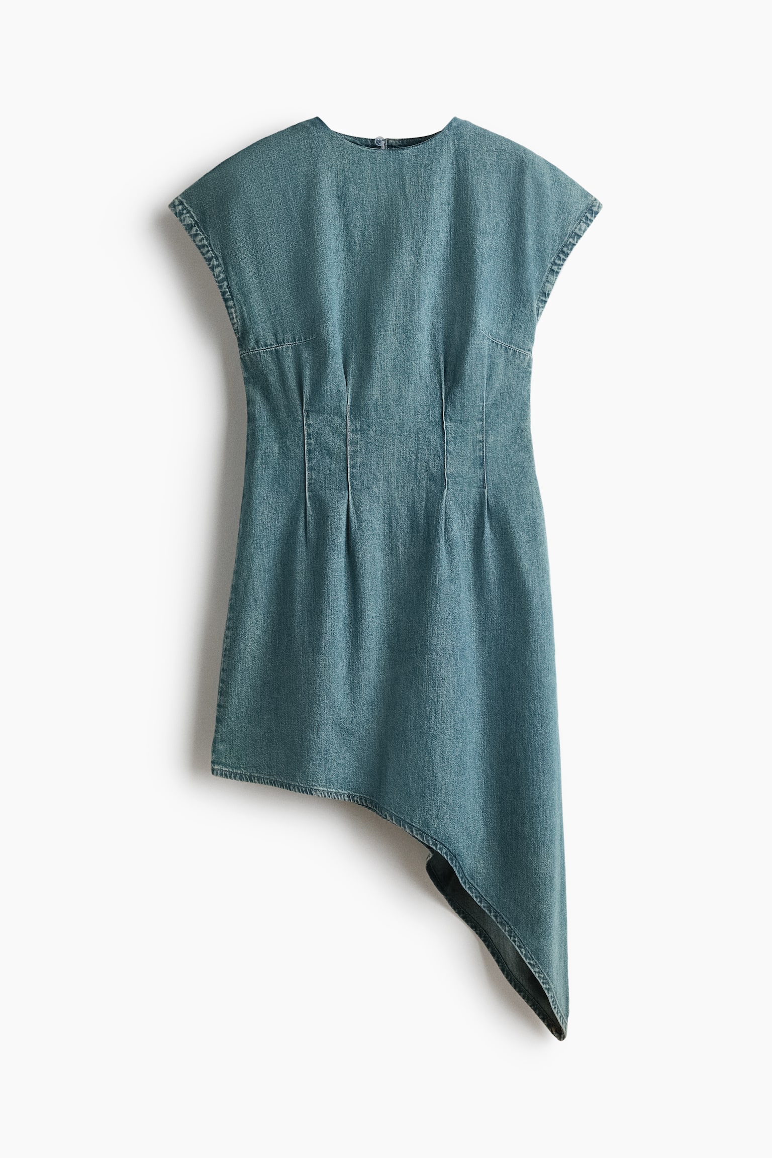 A blue-green denim dress is shown from the front, featuring a high round neckline, cap sleeves, and vertical waist darts that create a structured fit. The dress is designed with a dramatic asymmetrical hemline that drapes significantly lower on the right side.