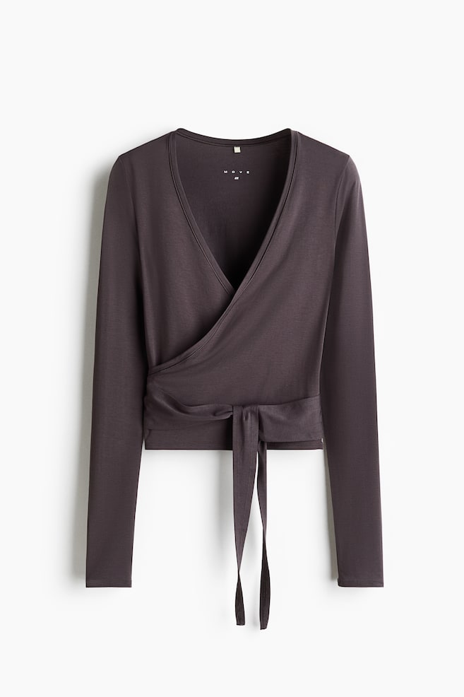 The front of a slim-fit sports top in soft modal jersey features a deep V-shaped neckline and a wrapover front with ties that wrap and tie around the waist. - 1