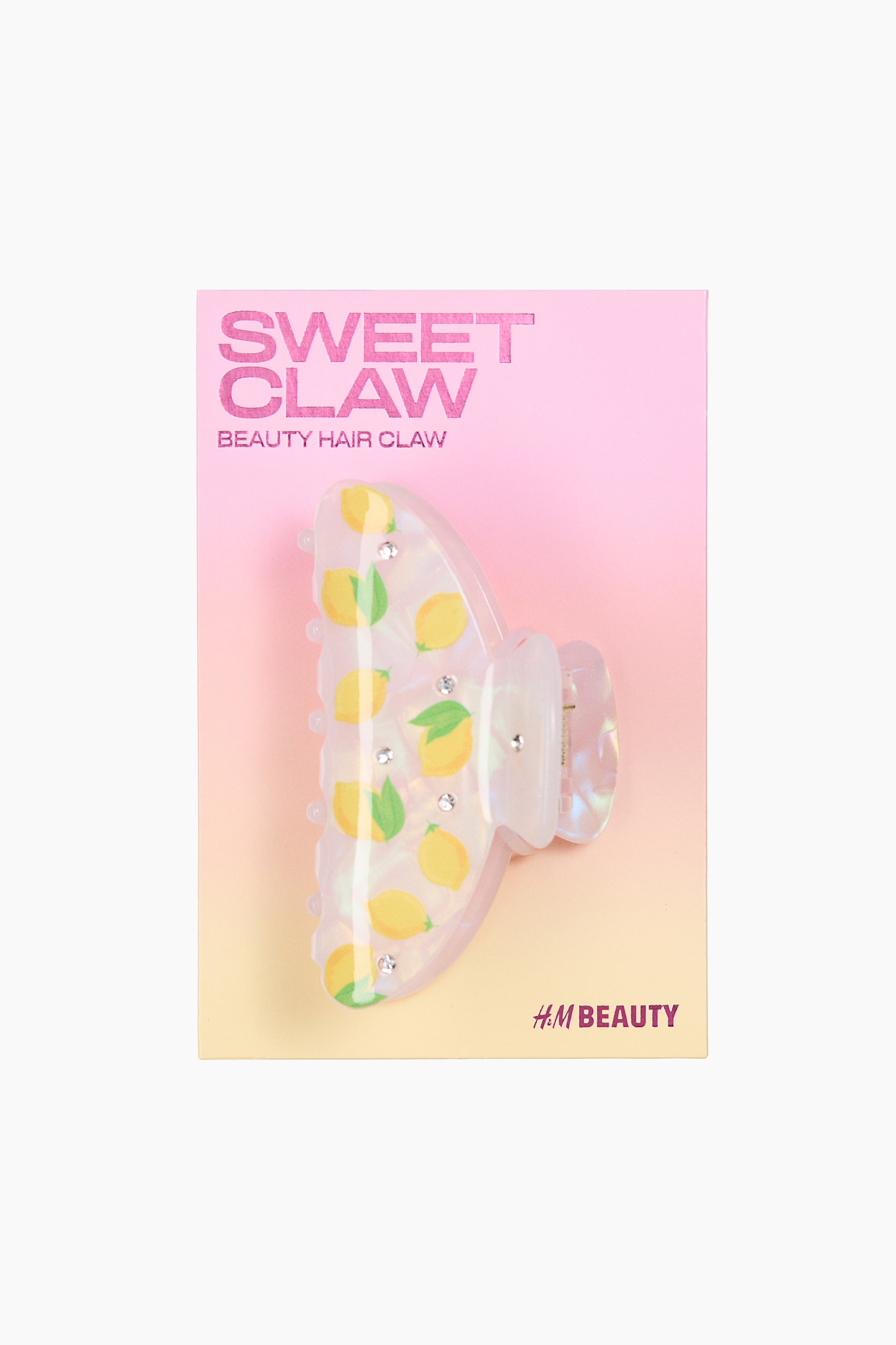 View larger image: A shimmering plastic hair claw is facing front, showcasing a charming lemon print and sparkling rhinestones.