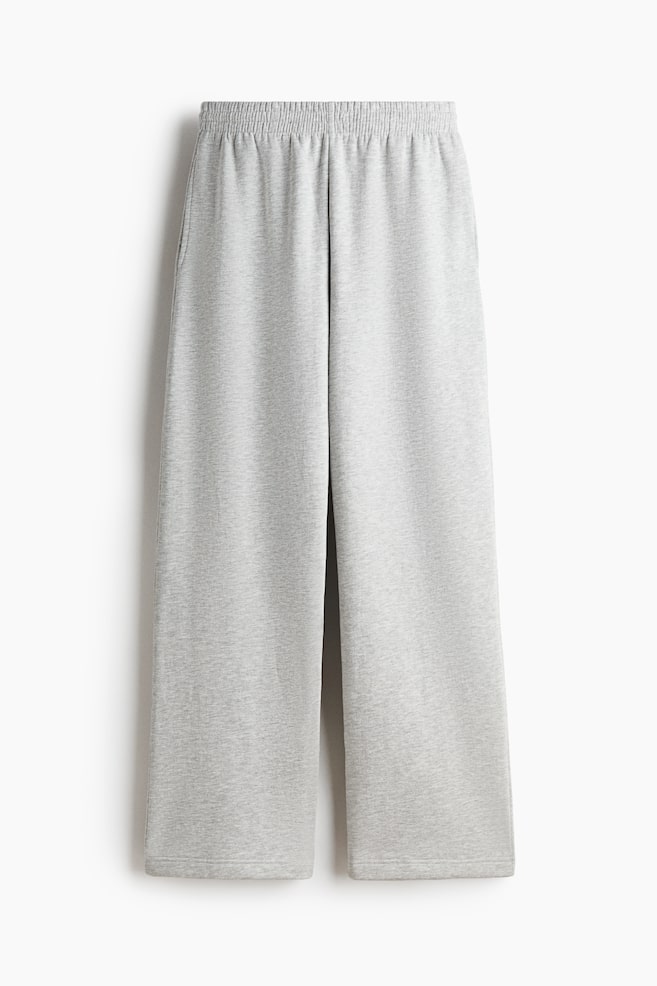 Light grey joggers are showcasing a front view, featuring an elasticated smocked waistband, side pockets, and straight legs in a heathered sweatshirt fabric. - 1