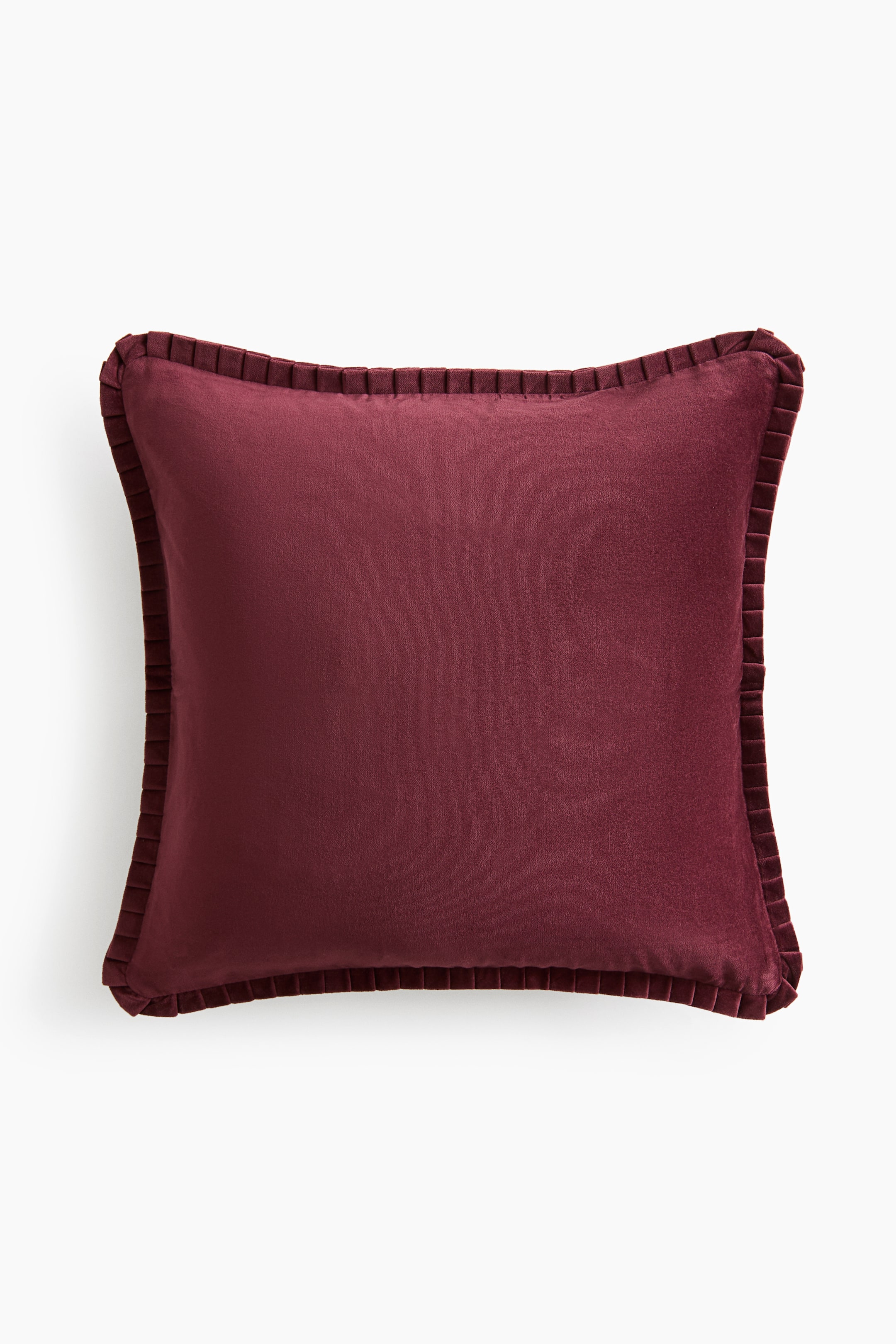 View larger image: A square burgundy velvet throw pillow is facing forward, showcasing a smooth, plush texture and matching pleated ribbon trim along all four edges.
