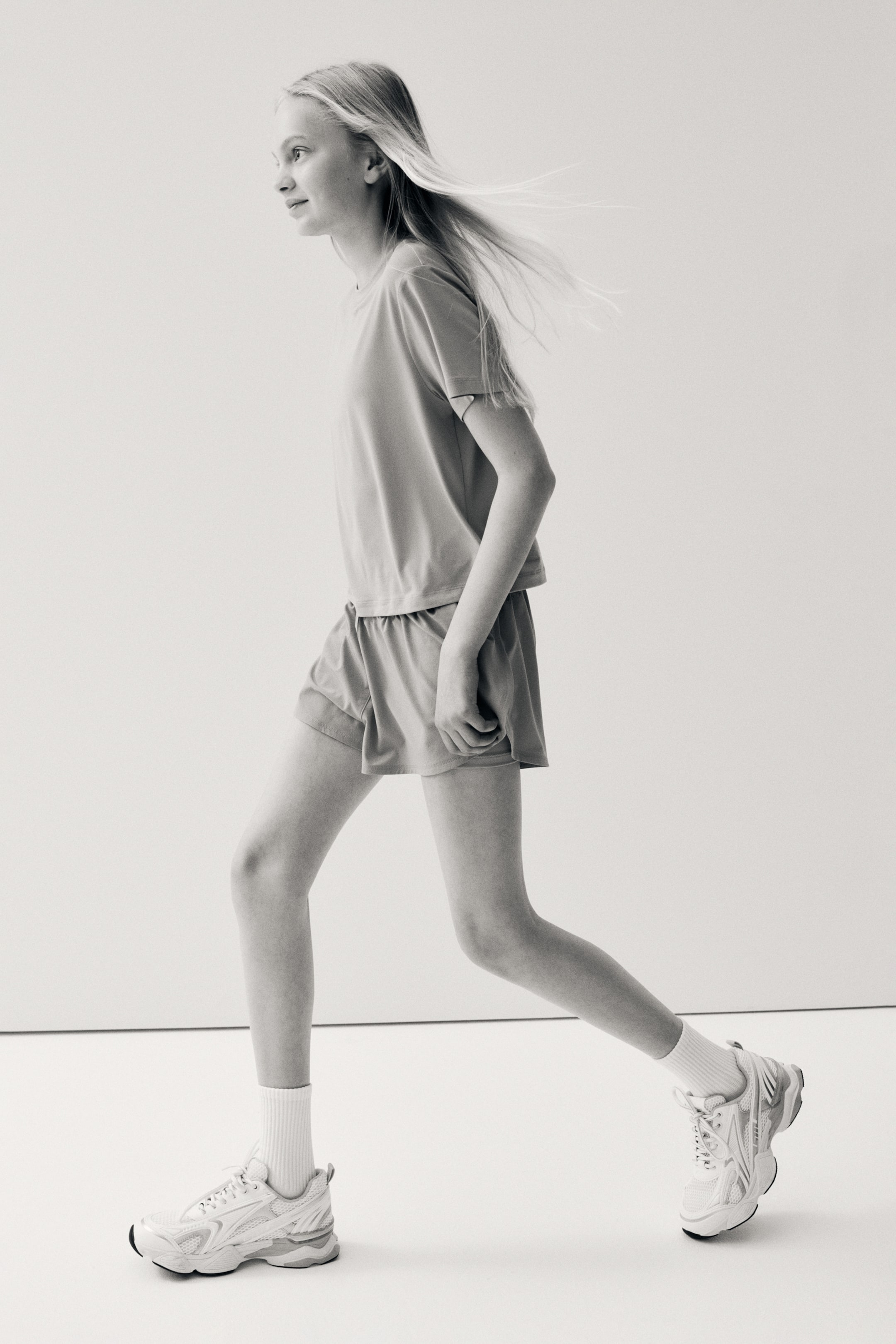 View larger image: Running shorts with DryMove? feature a relaxed fit and an elastic waistband, as viewed from the right side. They showcase a smooth, lightweight fabric and a mid-thigh length.