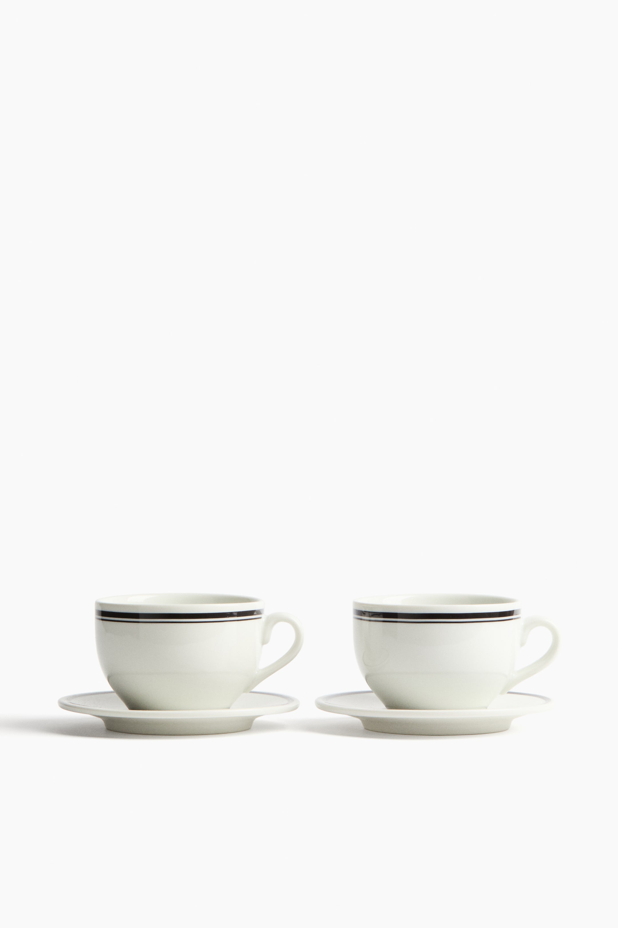 View larger image: 2-Pack Porcelain Cups with Saucers - White/black | H&M US 1