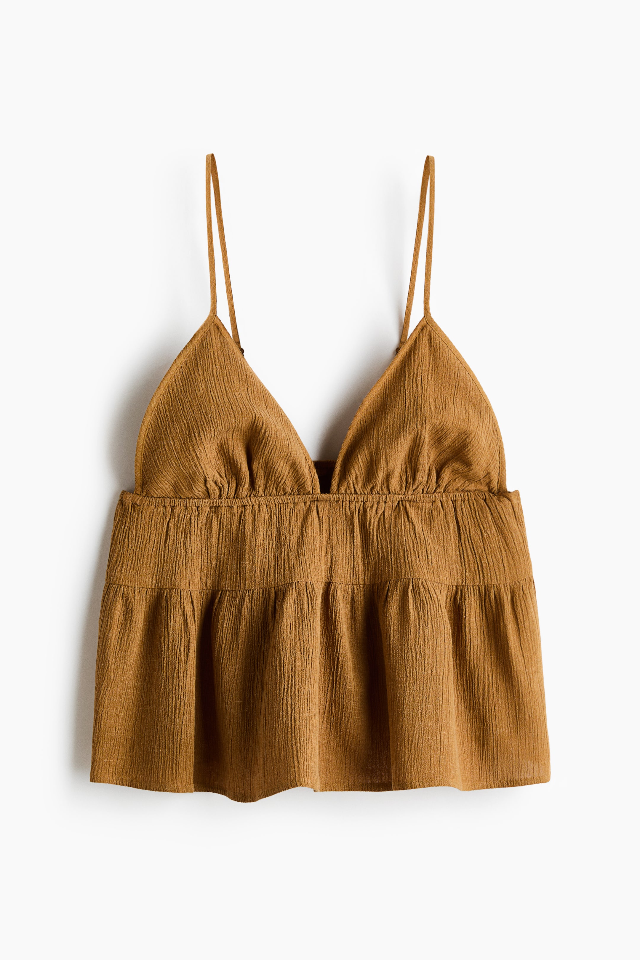 View larger image: A rust-coloured camisole top is shown from the FRONT, featuring a crinkled texture. It is designed with triangular cups, delicate spaghetti straps, a gathered waistline and a tiered peplum hem.