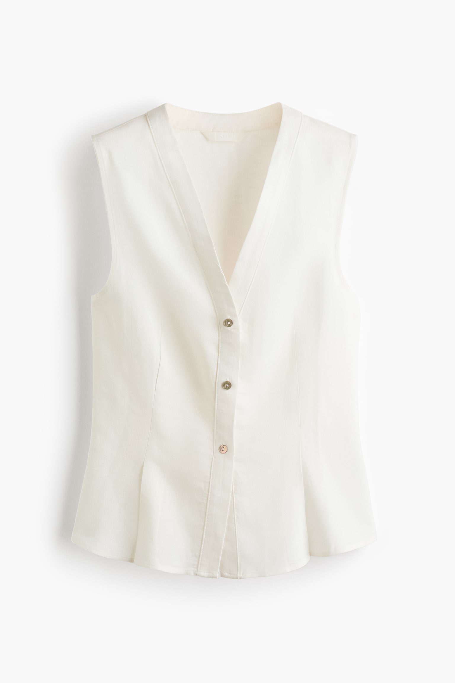 A cream sleeveless top is presenting front-facing, featuring a V-neckline and a front button placket with four iridescent buttons. Vertical seams are shaping the bodice, and a subtle pleat is detailing each side of the lower front hem. - 1