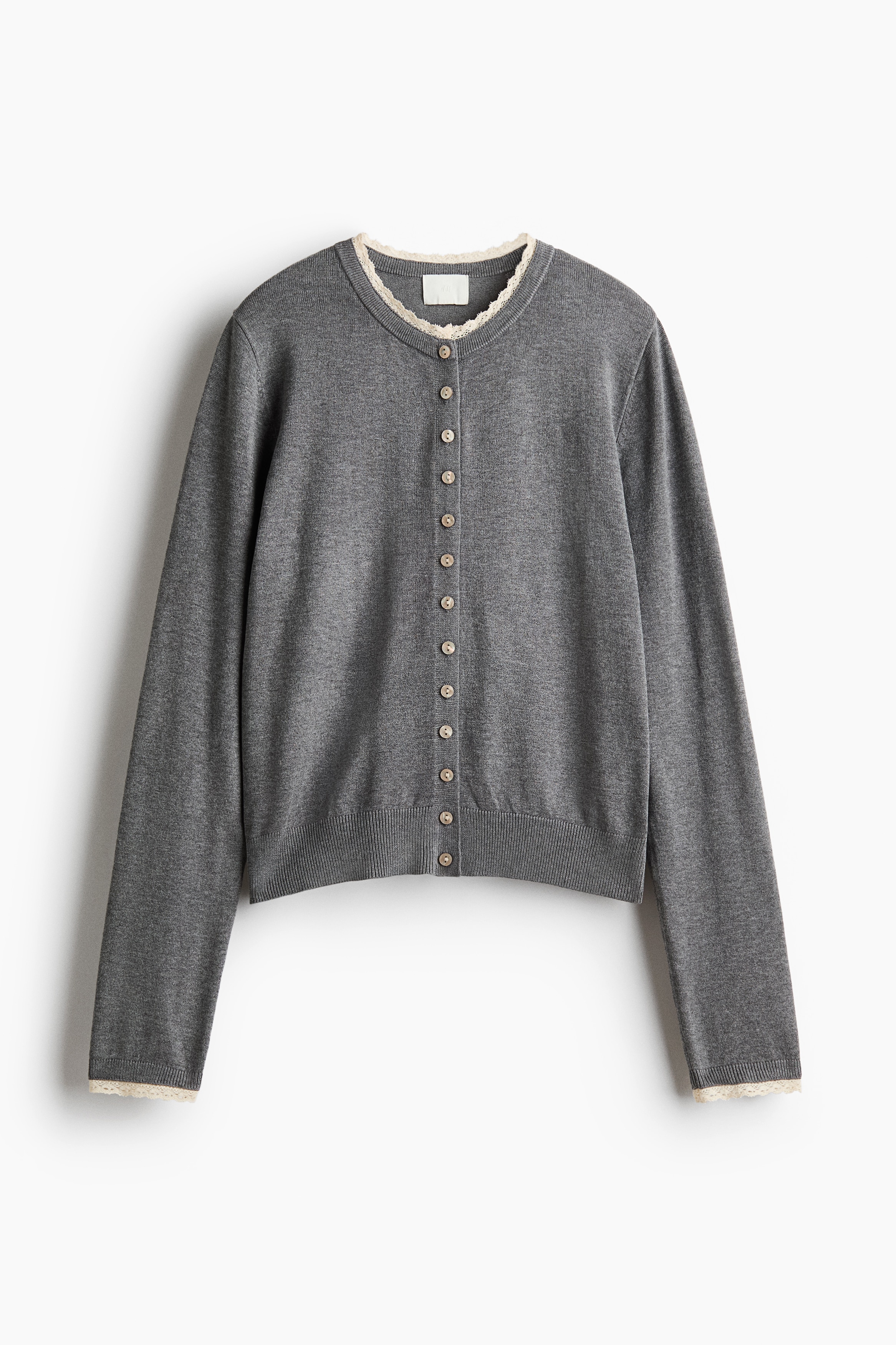 A fine-knit cardigan is shown from the front, featuring a round neckline with a delicate lace trim detail and a button-front closure with small, round buttons.