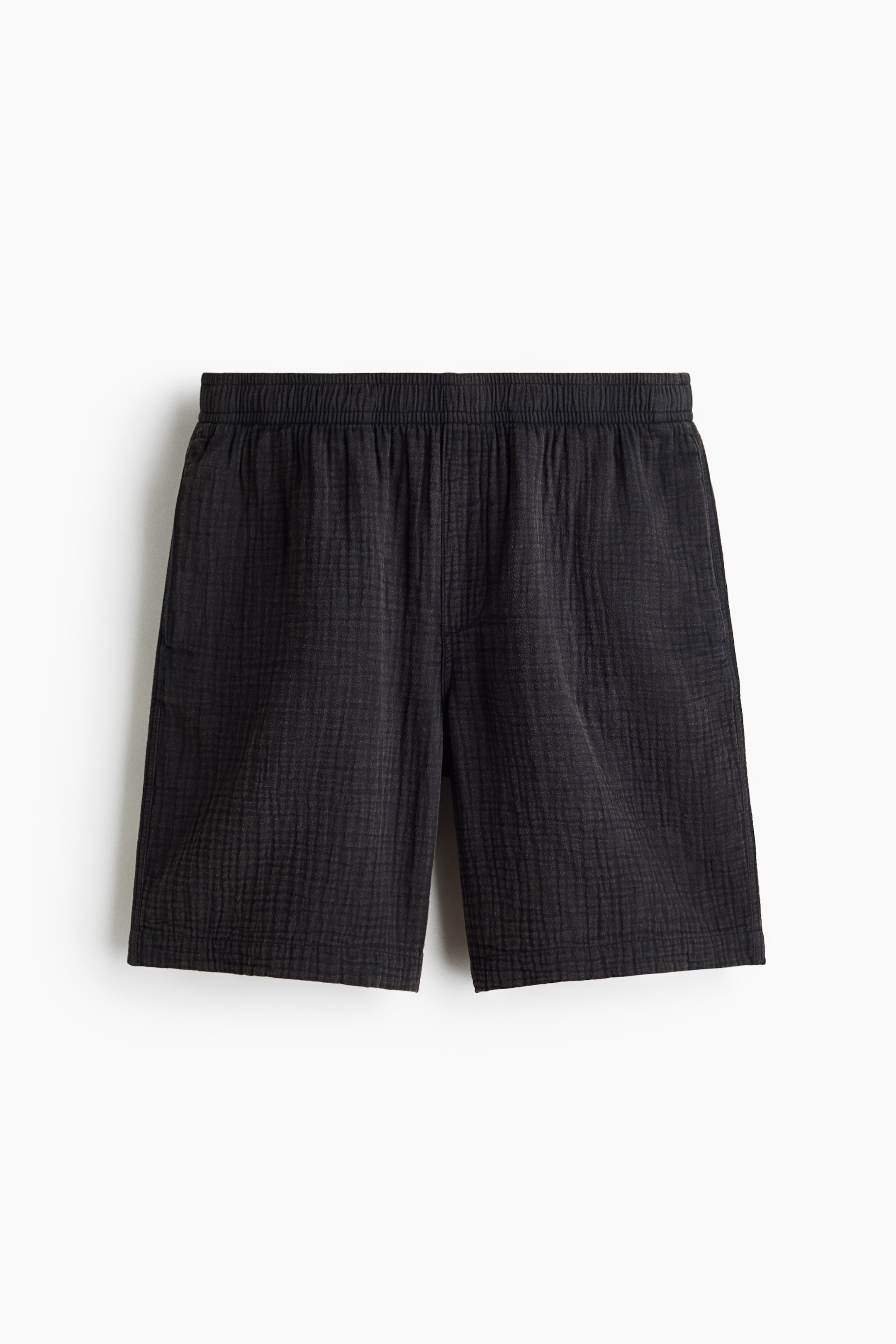 View larger image: Black shorts featuring an elastic waistband. The fabric showcases a crinkled texture.