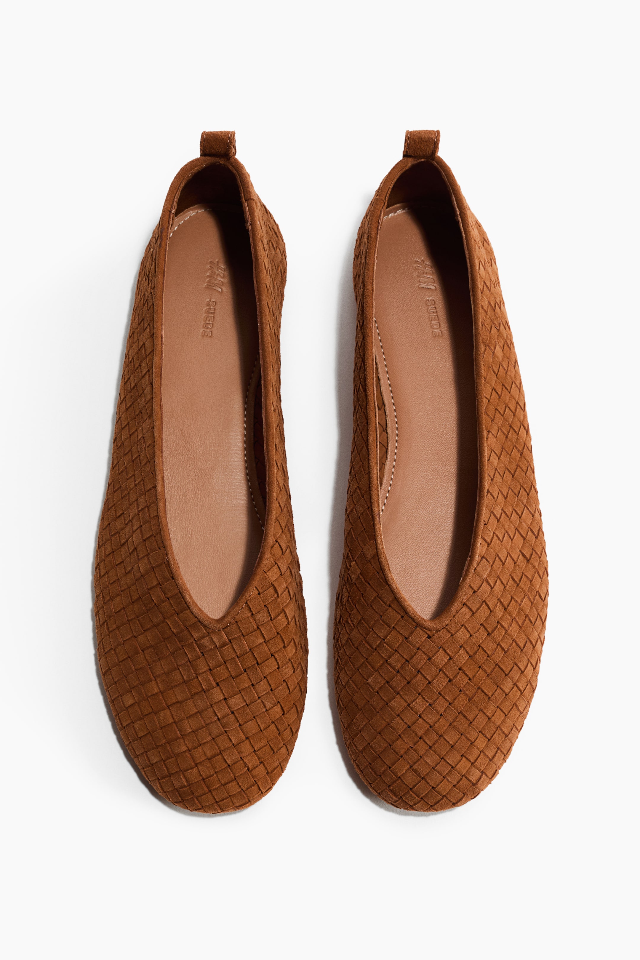 View larger image: Ballet pumps are shown as a pair, facing FRONT. They are crafted from brown braided leather and feature rounded toes, a V-shaped topline, a loop at the back, and visible leather linings and insoles.