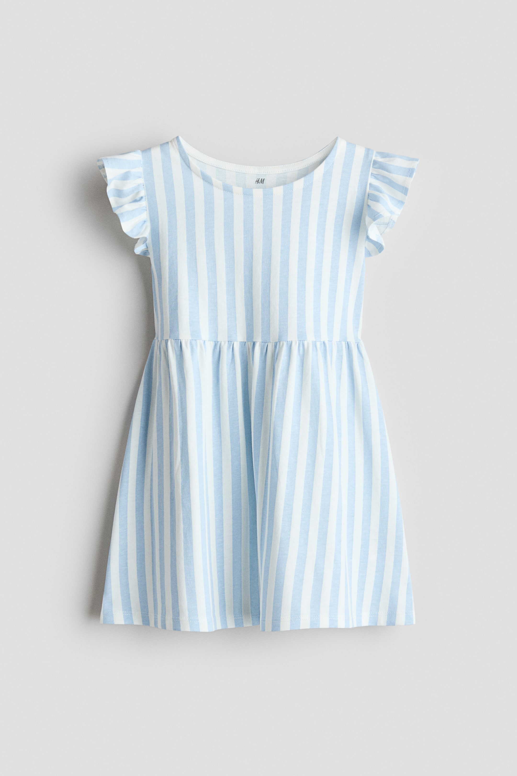 Xem ảnh lớn hơn: Một chiếc váy không tay bằng vải cotton jersey mềm mại được trình bày mặt trước, nổi bật với các sọc dọc màu xanh nhạt và trắng. Thiết kế với cổ tròn, diềm xếp quanh lỗ tay và đường may nhún ở eo.