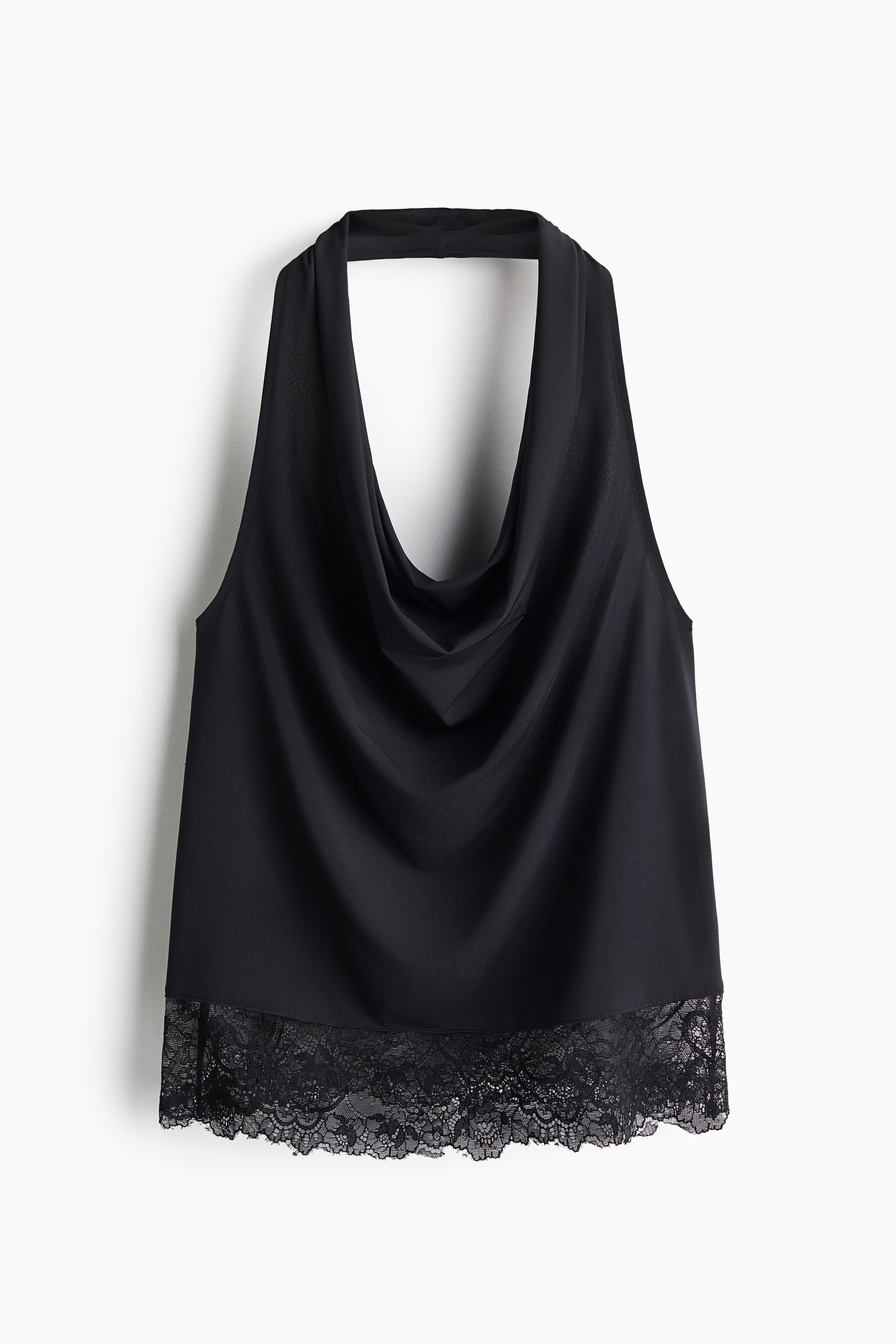 A black halterneck top featuring a draped cowl neckline and a delicate lace trim along the hem is being worn by the model. The top is paired with wide-leg blue jeans.