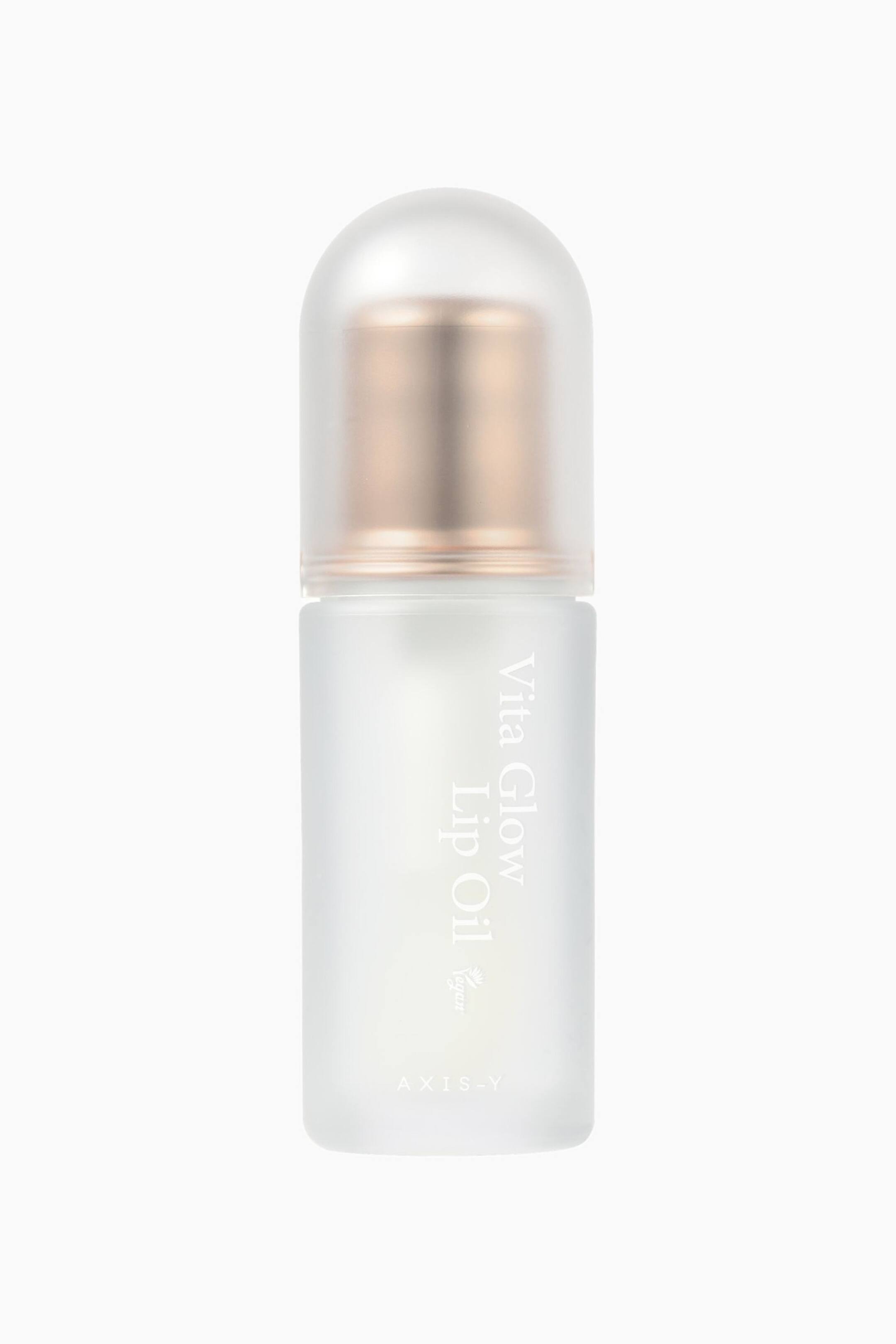 Visa större bild: En läppolje-flaska står upprätt, vänd framåt. Den har en frostad, transparent kropp med "Vita Glow Lip Oil" och "AXIS-Y" tryckt vertikalt, och är toppad med en genomskinlig kupolformad kork som avslöjar en roséguldfärgad komponent.