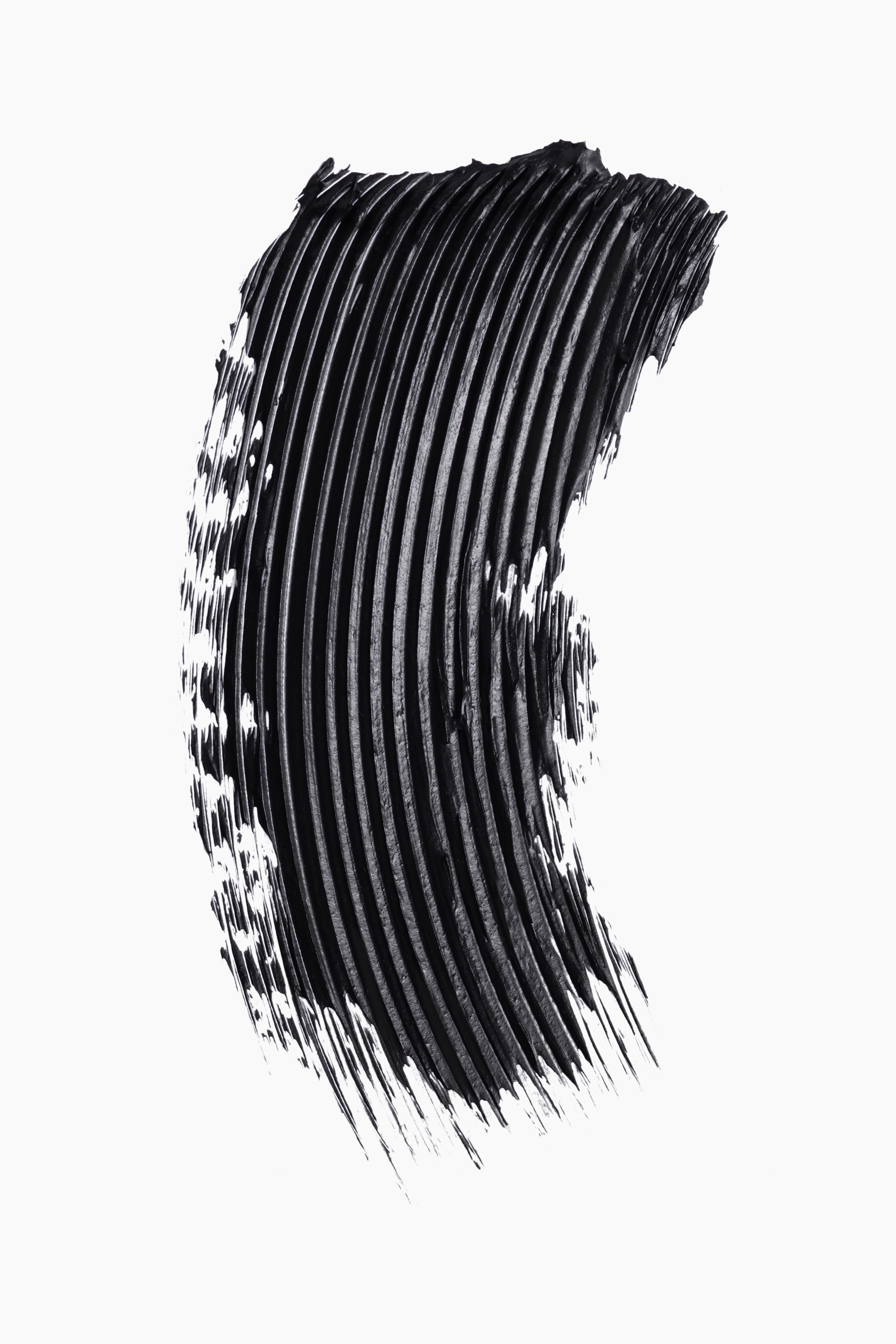 View larger image: A black mascara swatch is displaying a thick, curved swipe with distinct, parallel grooves.