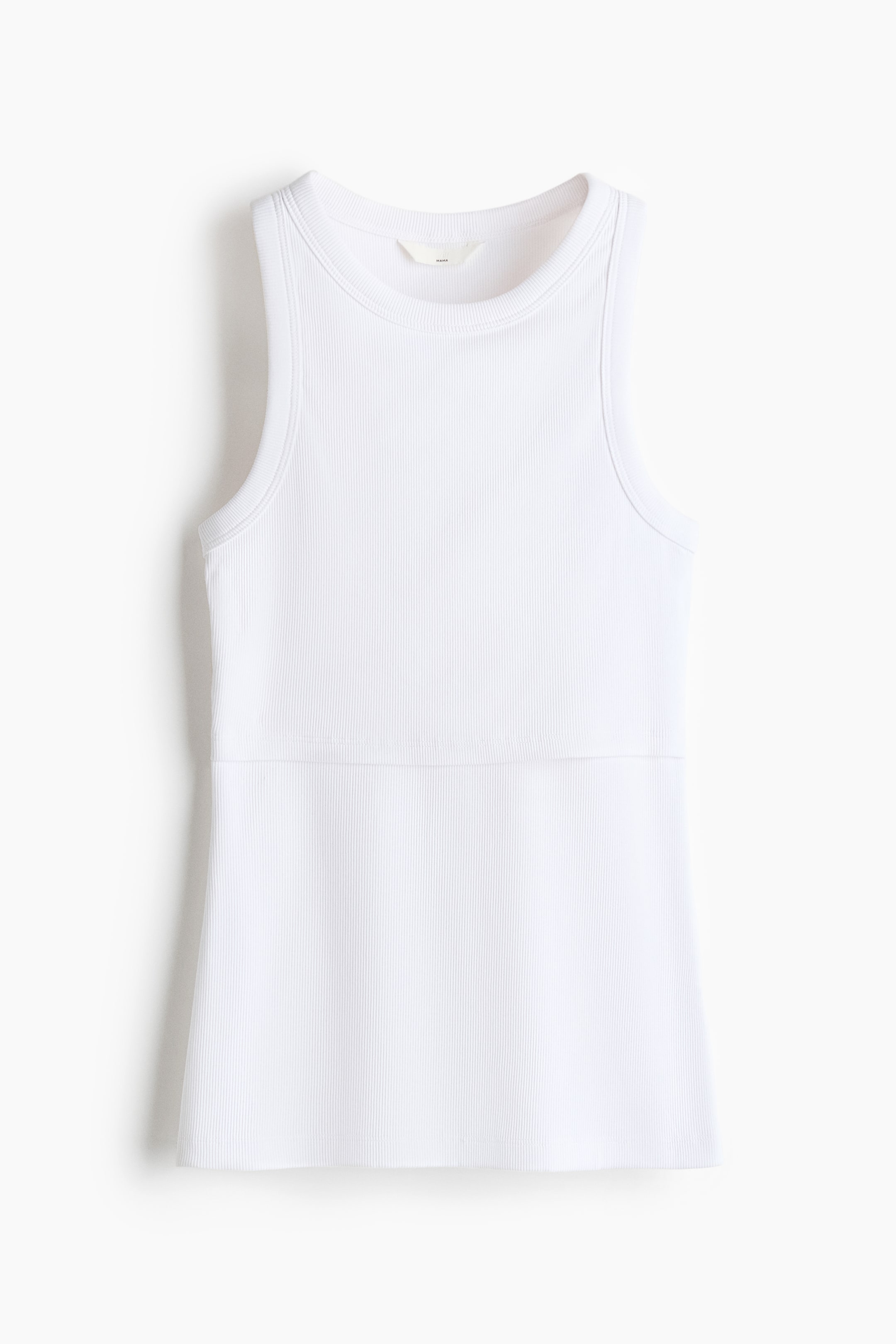 View larger image: A white tank top showcases a ribbed knit texture throughout, featuring a round neckline and wide sleeveless armholes. A horizontal seam is visible across the midsection, separating the fitted top from the slightly flared bottom.