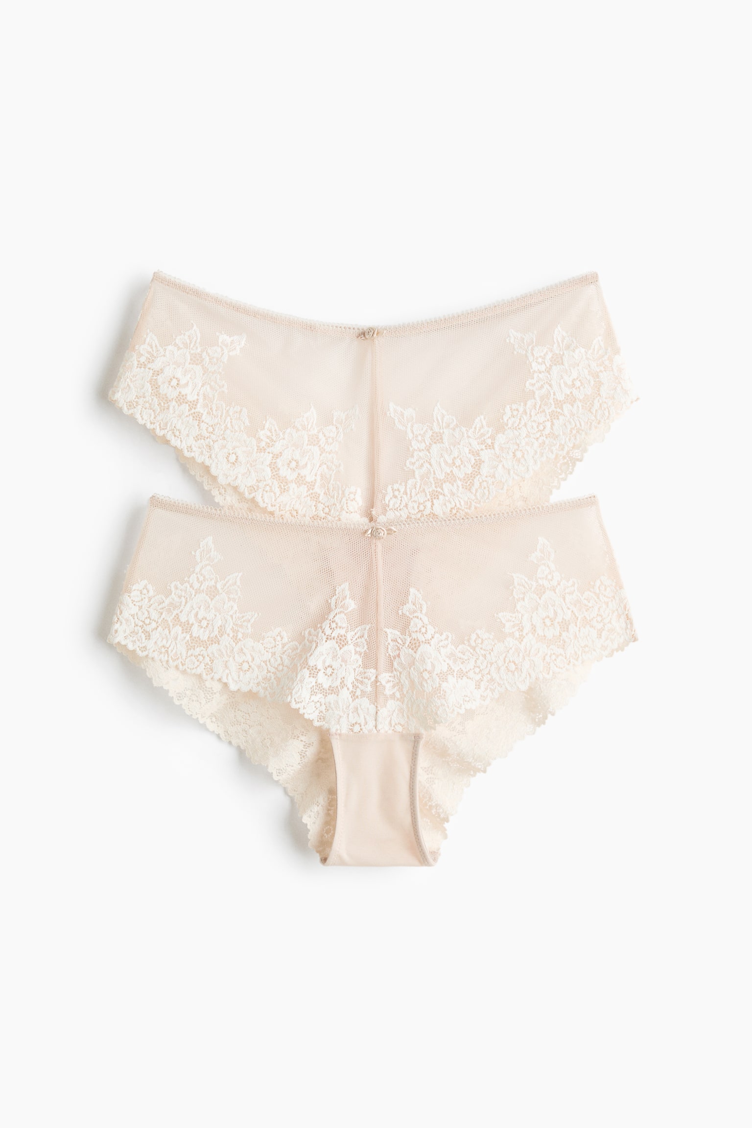 Two pairs of briefs, showcasing light beige mesh and off-white floral lace, are laid flat with their front sides facing upwards. They feature a small bow embellishment at the centre front, a mid-waist fit, a lined gusset, and medium coverage at the back. - 1