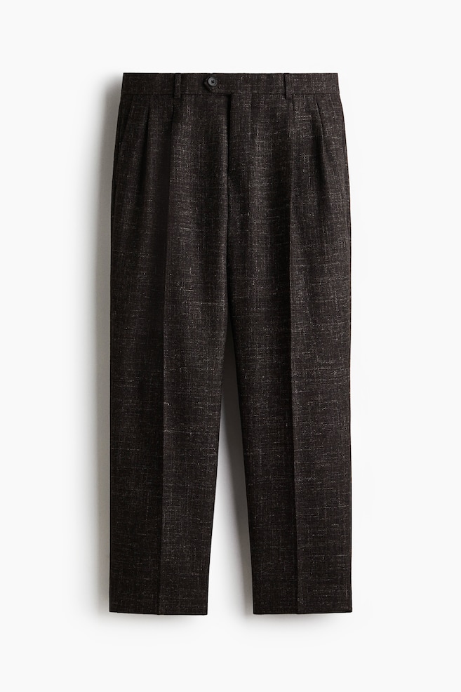 Dark brown melange pants are presenting a front view, featuring a button closure, belt loops, and two forward-facing pleats on each side. The pants are displaying a sharp central crease down each leg and a straight hem. - 1