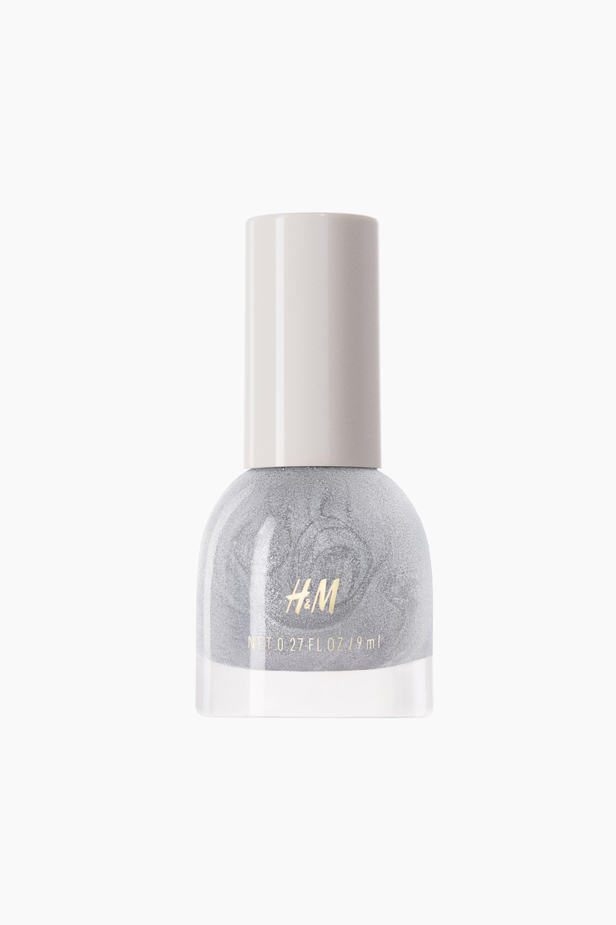 View larger image: A bottle of nail polish is standing upright in a front view, showcasing a shimmery, glittery silver metallic shade with subtle swirl patterns visible through the clear glass. The bottle features a rounded dome shape with a thick clear base and is topped with a tall, cylindrical off-white cap.