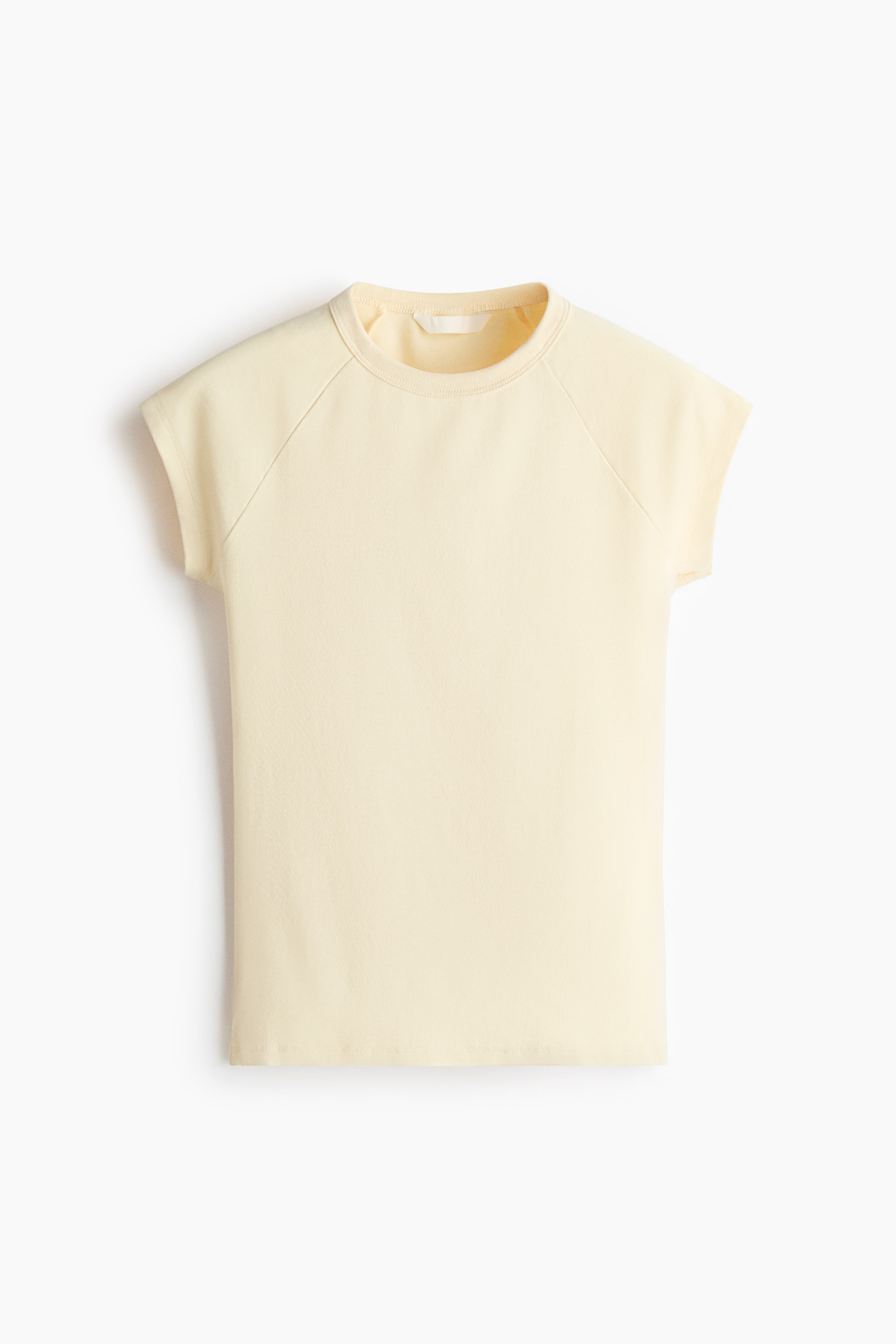 View larger image: A gentle, pale yellow fitted t-shirt is displayed front-facing, showcasing a round, rib-trimmed neckline, short raglan sleeves, and a straight-cut hem.