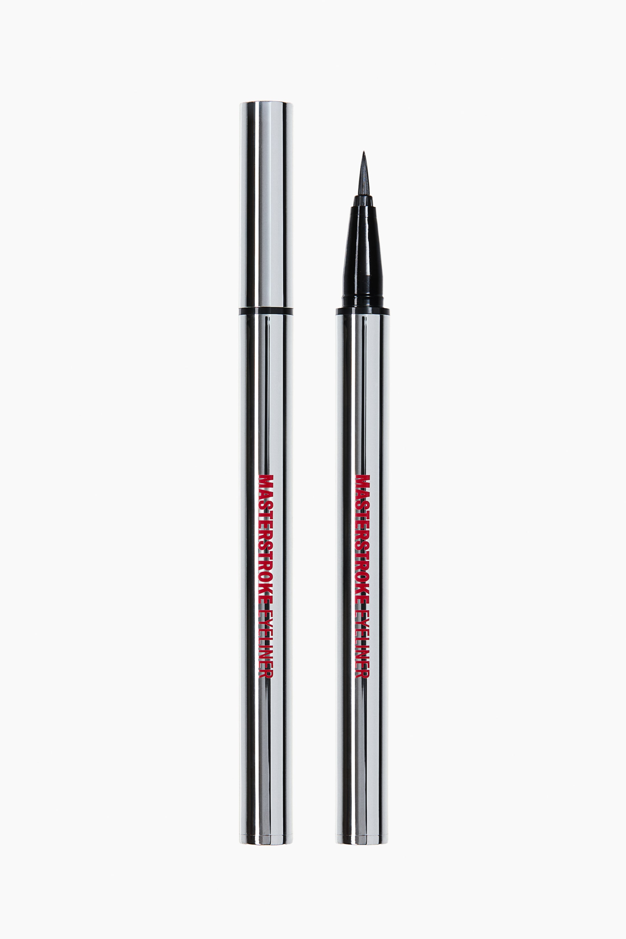 Ampliar la imagen: Un delineador líquido plateado y reflectante se muestra en sus dos partes de pie, una con tapa y la otra destapada para revelar un aplicador de punta de fieltro negro. Ambas partes presentan "MASTERSTROKE EYELINER" en texto rojo a lo largo de su frente.