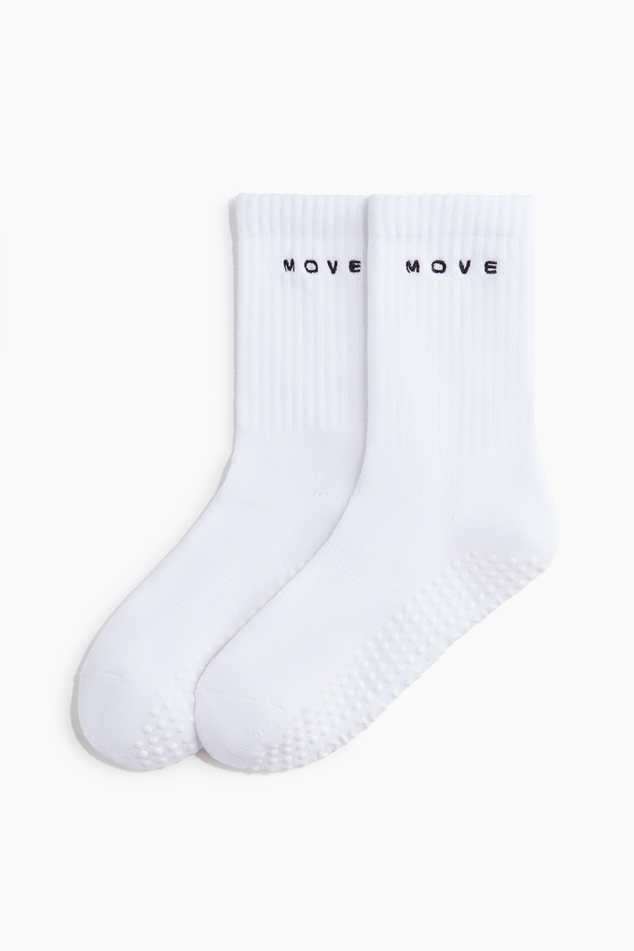 View larger image: A pair of white, fine-knit sports socks is shown front-facing, featuring ribbed shafts with black "MOVE" embroidery and anti-slip protectors across the soles.