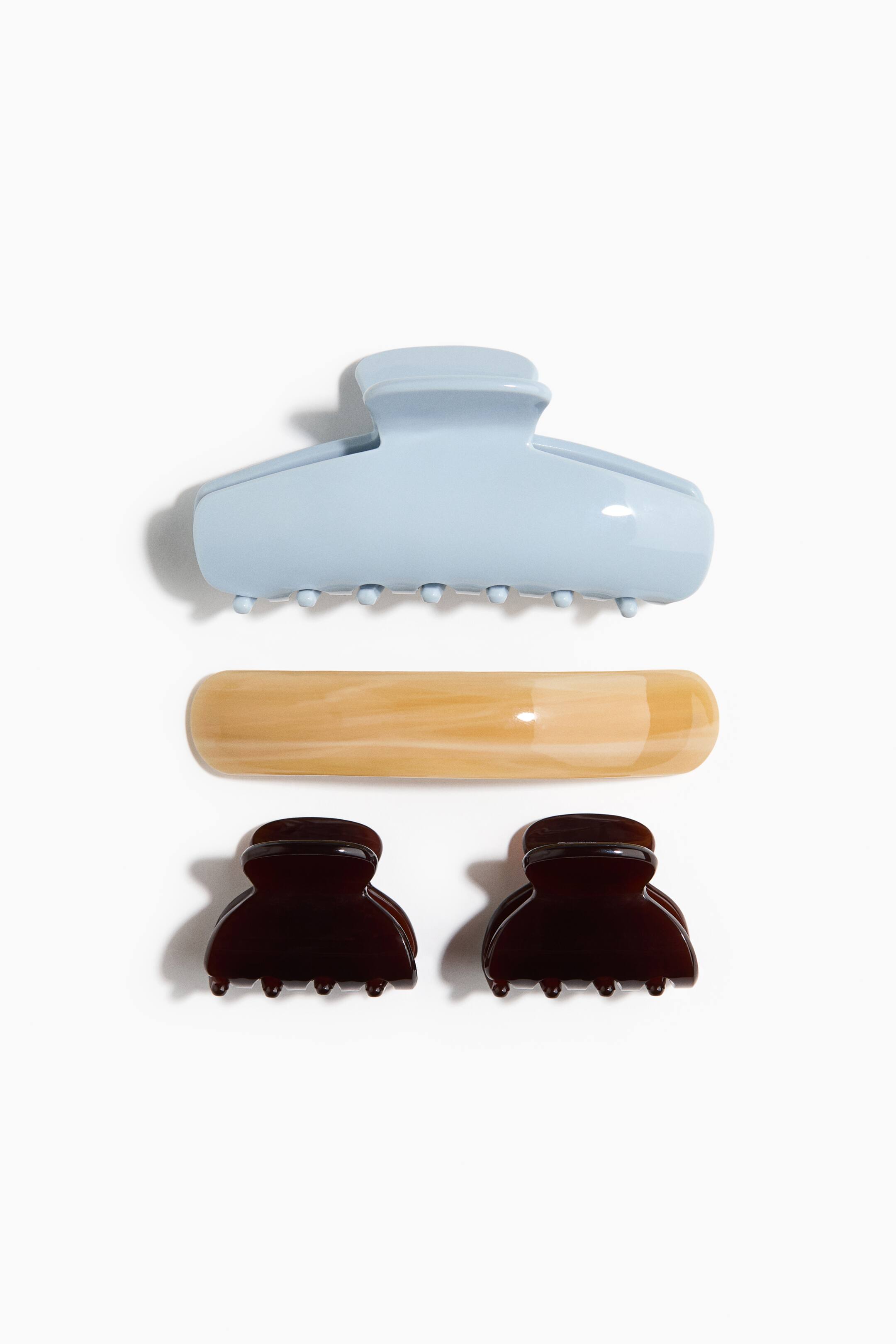 Ver imagen más grande: Se presenta un conjunto de accesorios para el cabello que incluye un gran clip de garra de color azul claro, una horquilla alargada con diseño en mármol beige y dos pequeños clips de garra de color marrón oscuro.