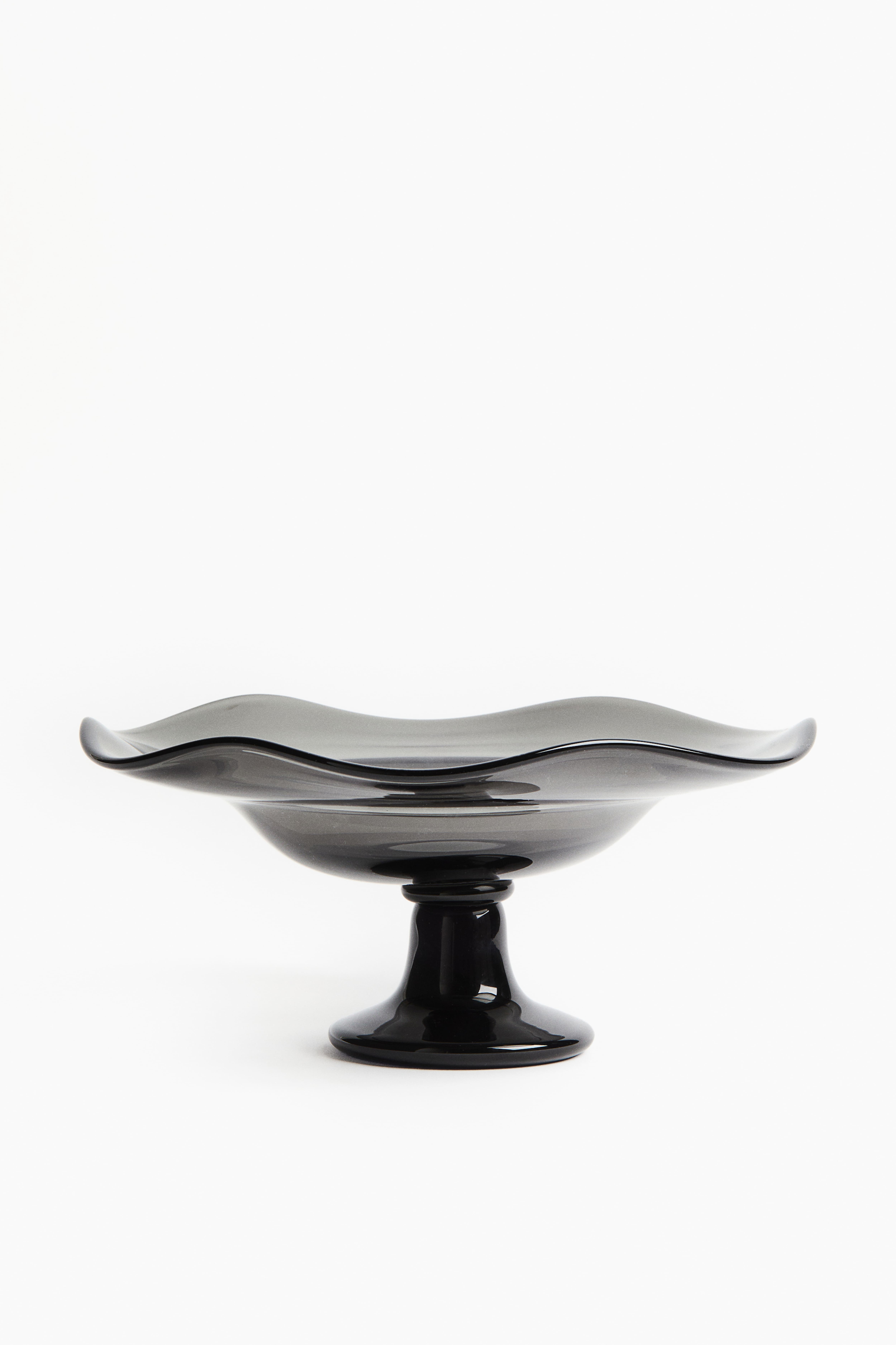 Assiette de service irrégulière sur pied en verre