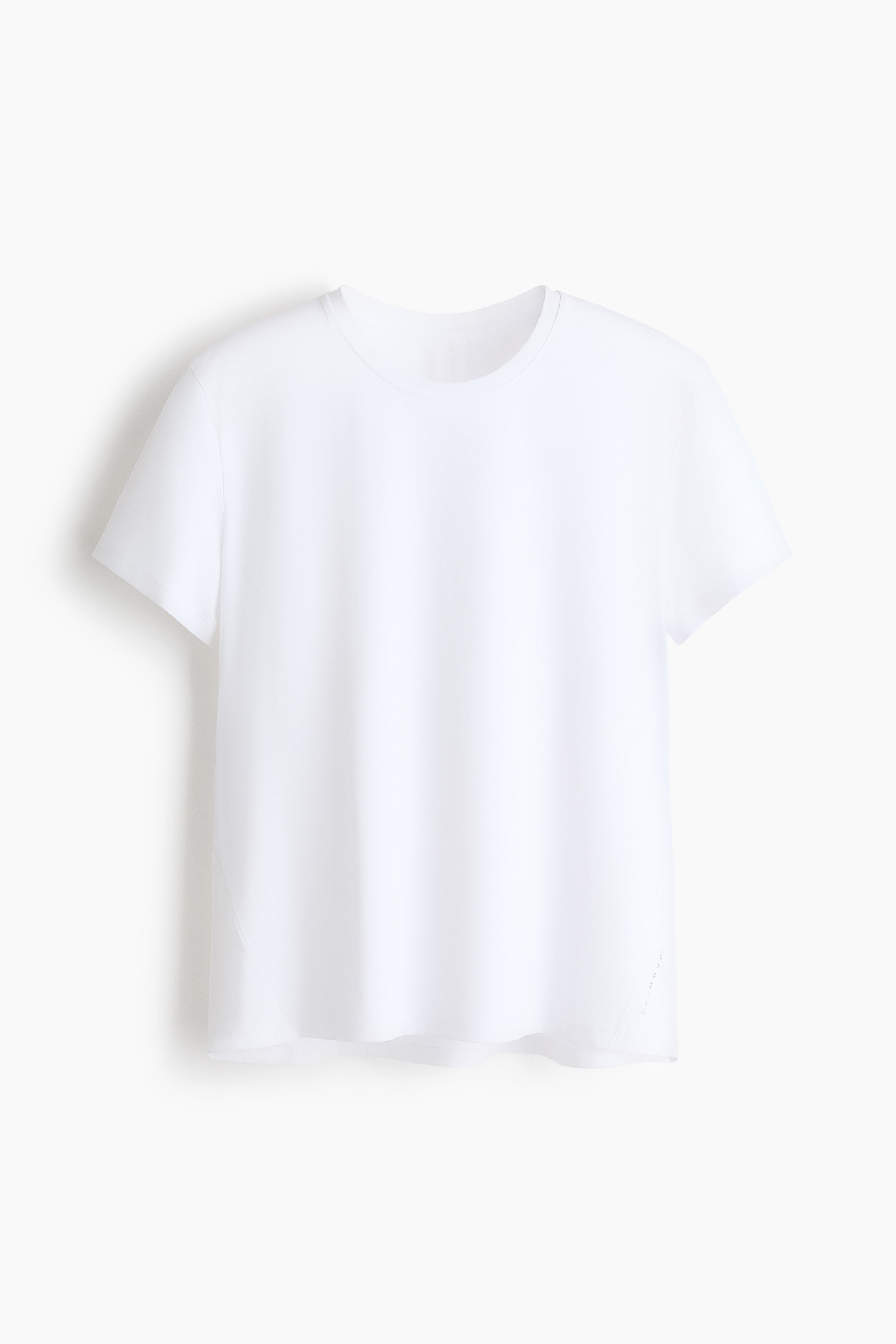 Büyük resmi görüntüle: Beyaz bir tişört, yuvarlak yaka ve kısa kollu ön kısmını sergiliyor. Tişört, hafif kavisli bir etek ucu ve sağ alt tarafında küçük delikler gösteriyor.