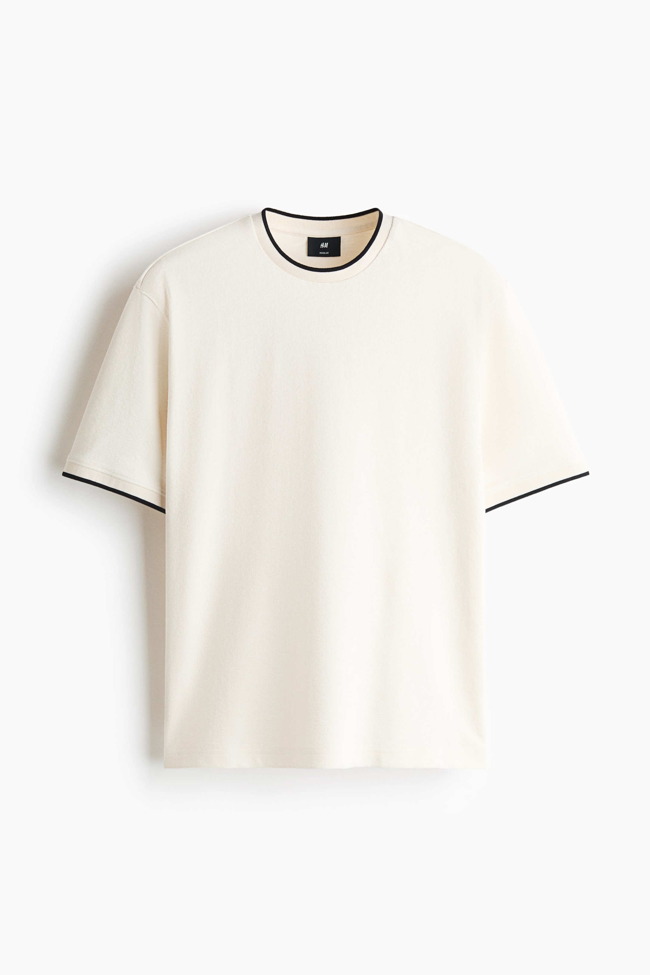 View larger image: A cream-coloured, heavyweight cotton jersey T-shirt is shown in a front-facing view, featuring a regular fit, short sleeves, and a straight hem. The T-shirt showcases contrasting thin black trims along its ribbed crew neckline and sleeve cuffs.